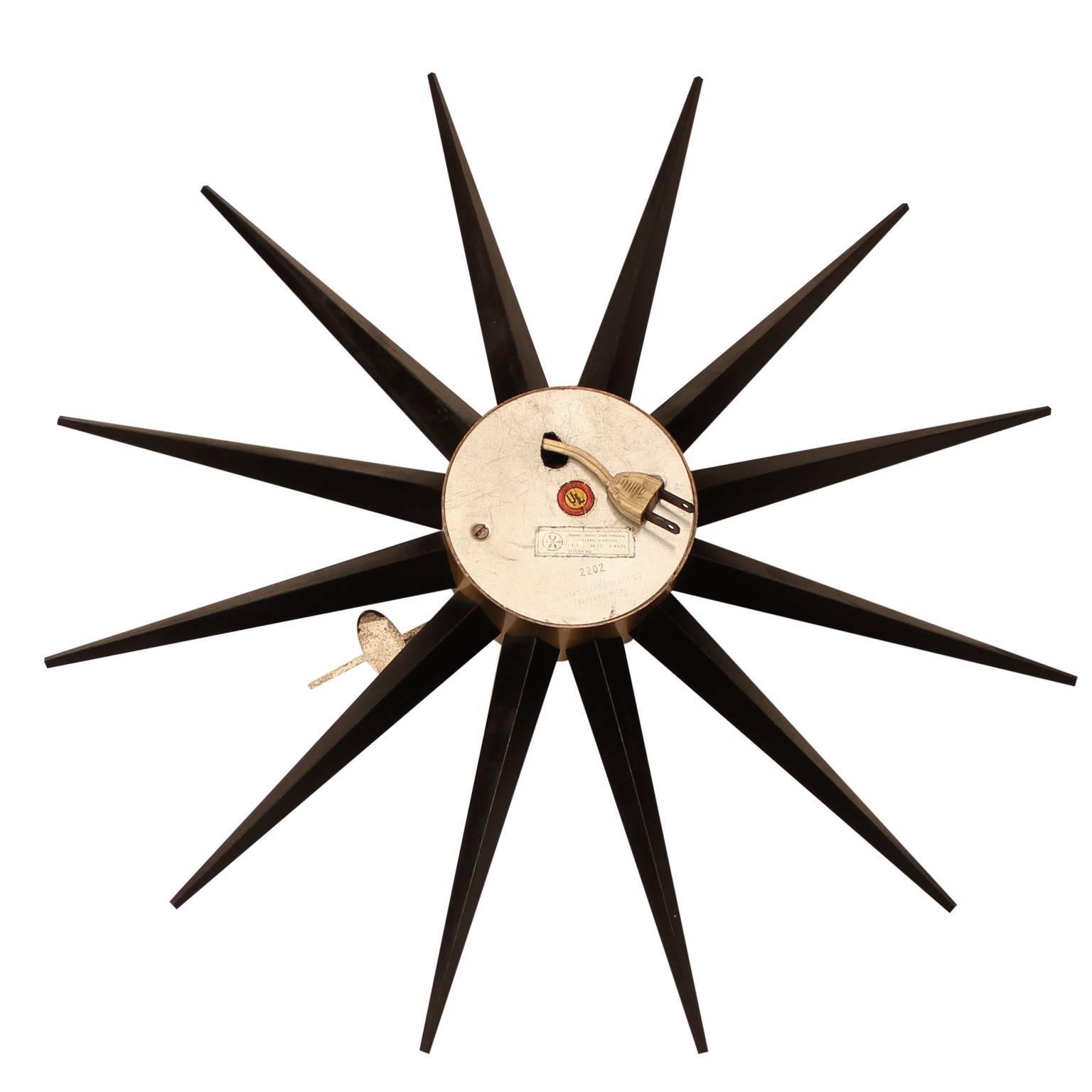A George Nelson for Howard Miller Sunburst Clock, Model #2202. 

To avoid the appearance of cords, this piece was rewired to have the electrical plug extend from the back of the clock's base, which the most recent owner would plug into a
