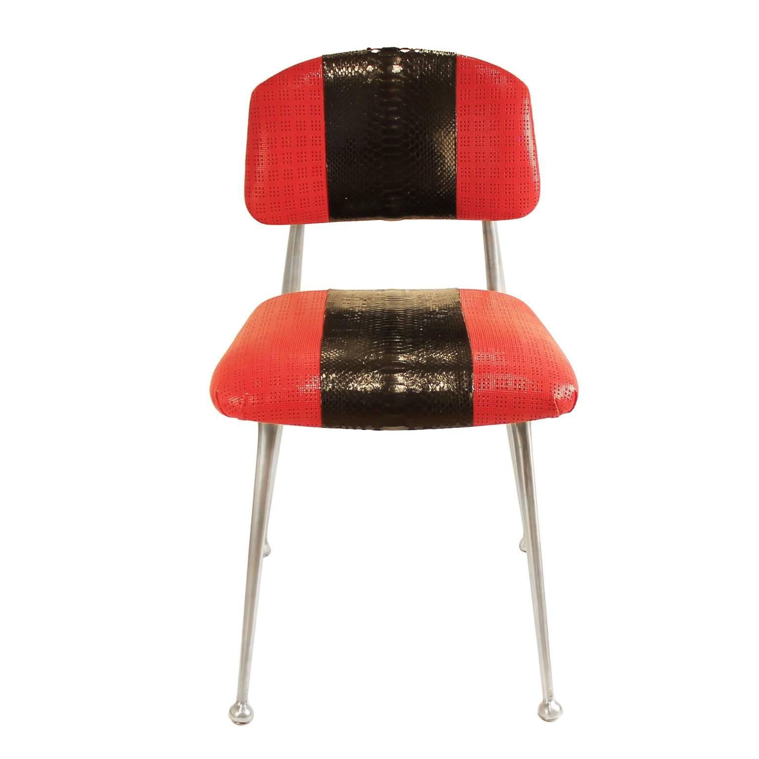 This is an exquisite accent vintage gazelle chair attributable to Shelby Williams recently reupholstered with black python and lipstick red perforated lambskin leather. The center racing stripe in python contrasts starkly against the perforated