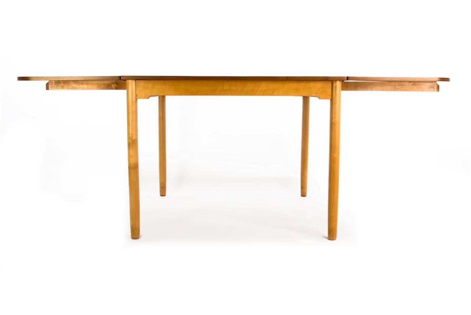 Exquisite craftsmanship on this walnut and maple library table that extends to 78 inches in width. 