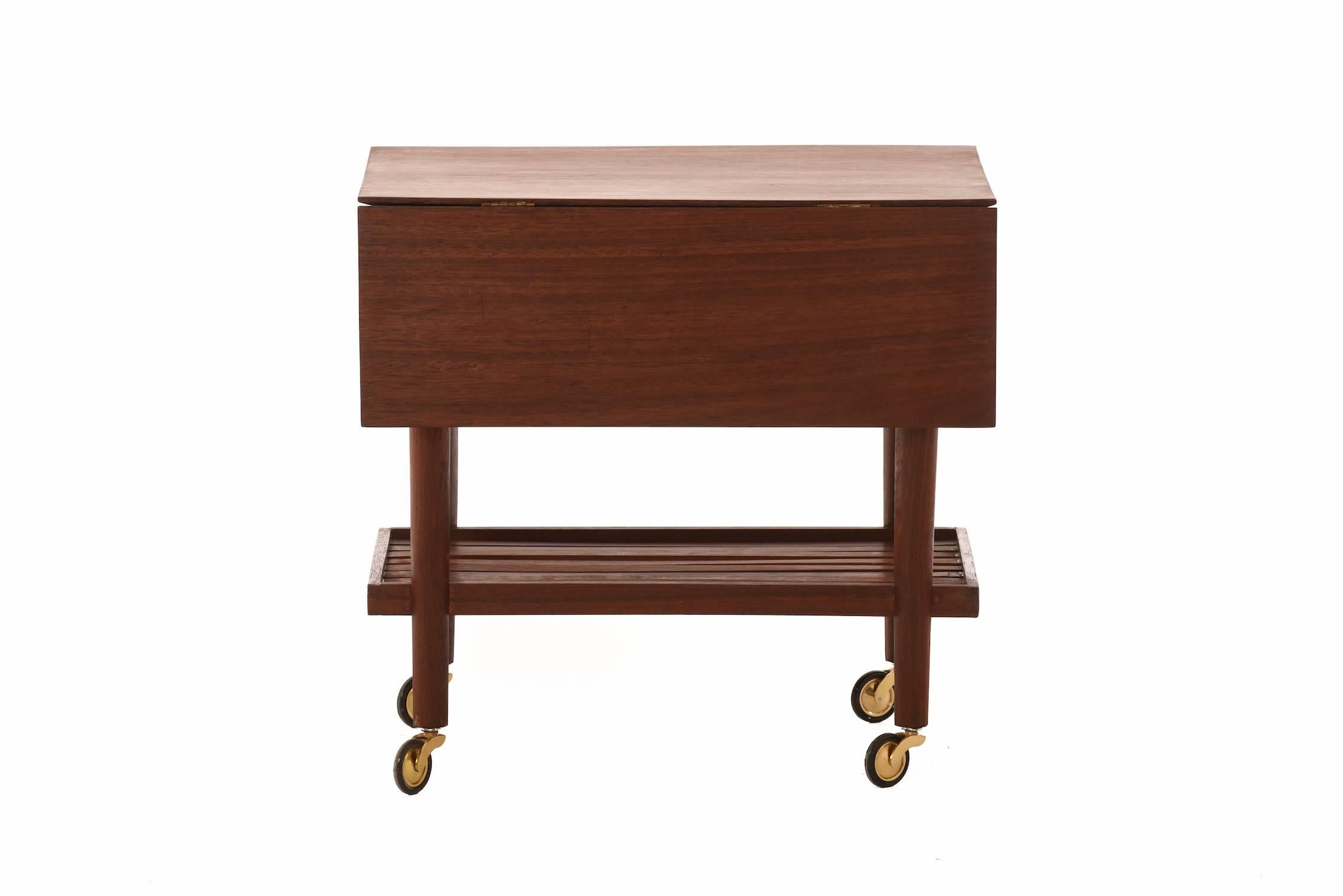 Transitional Modern serving cart extends to 34.25" with drop leaves open. Solid wood top with internal bevel. Gorgeously grained African teak.

Professional, skilled furniture restoration is an integral part of what we do every day. Our goal