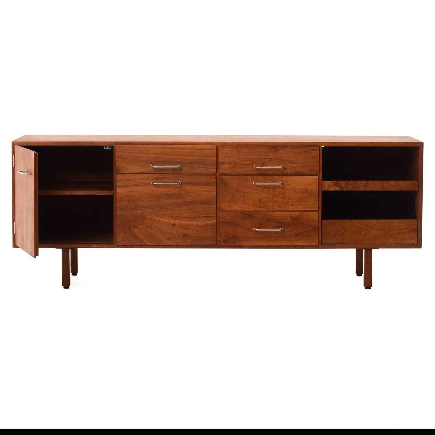 Lovely oiled walnut office credenza by Jens Risom. Shelf in left interior cupboard is adjustable. Right side (facing) boasts a roller tray and paper trough. Ventilated through back side.

Professional, skilled furniture restoration is an integral