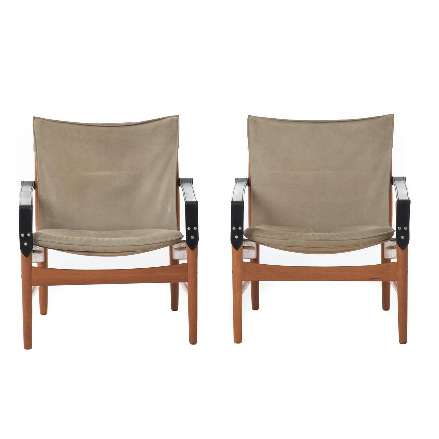 Remarkable “Antelope” Safari or Hunting lounge chair by Hans Olsen, produced by Viskadalens Möbler, Denmark 1960s. These chairs are made from old growth teak wood finished in oil.  The suede slings are a beige-grey tone that shows their character