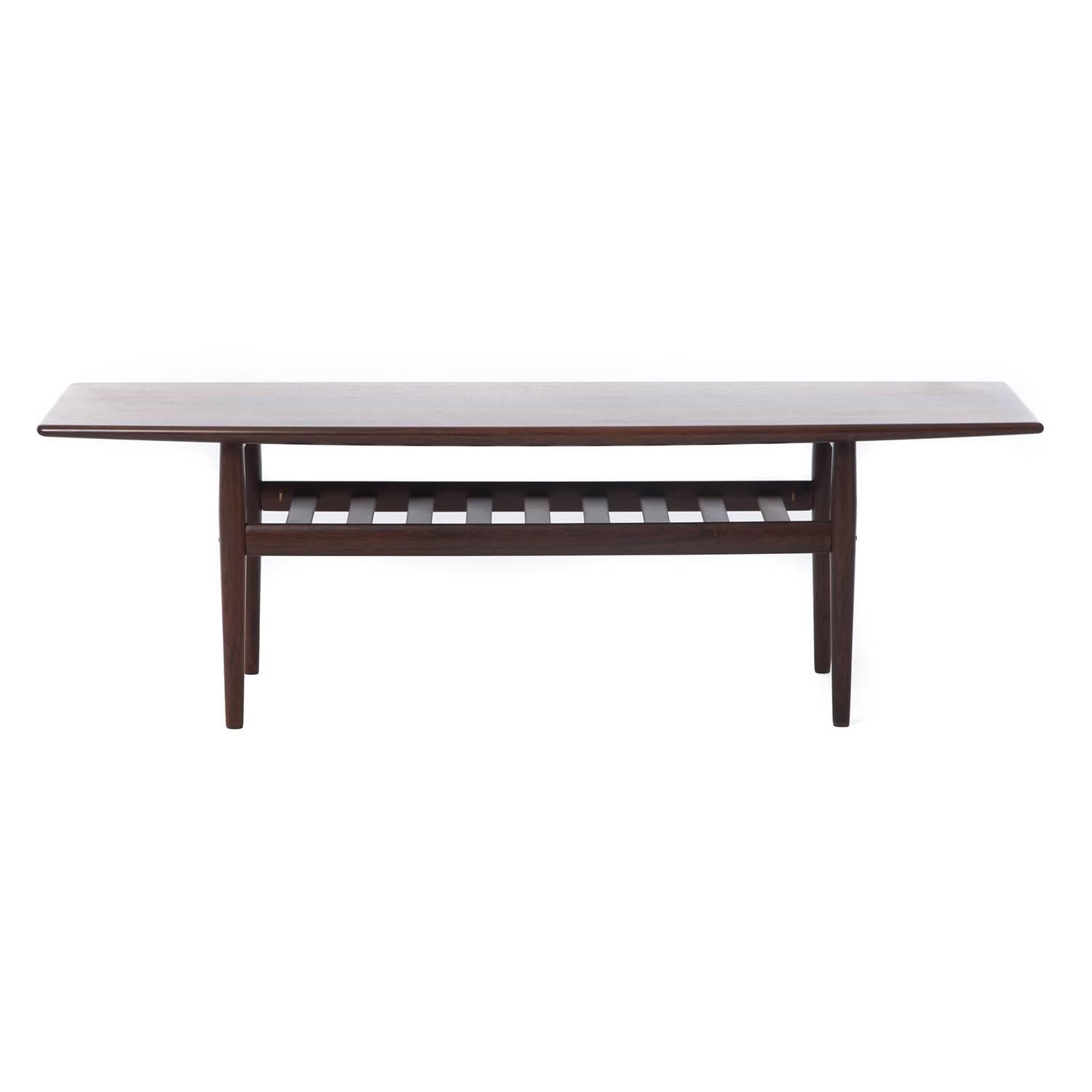 Lovely vintage original table in excellent and completely restored condition. Natural stripe in figuring on top makes a nice statement. Sturdy slat shelf underneath, Greta Jalk design.

Professional, skilled furniture restoration is an integral