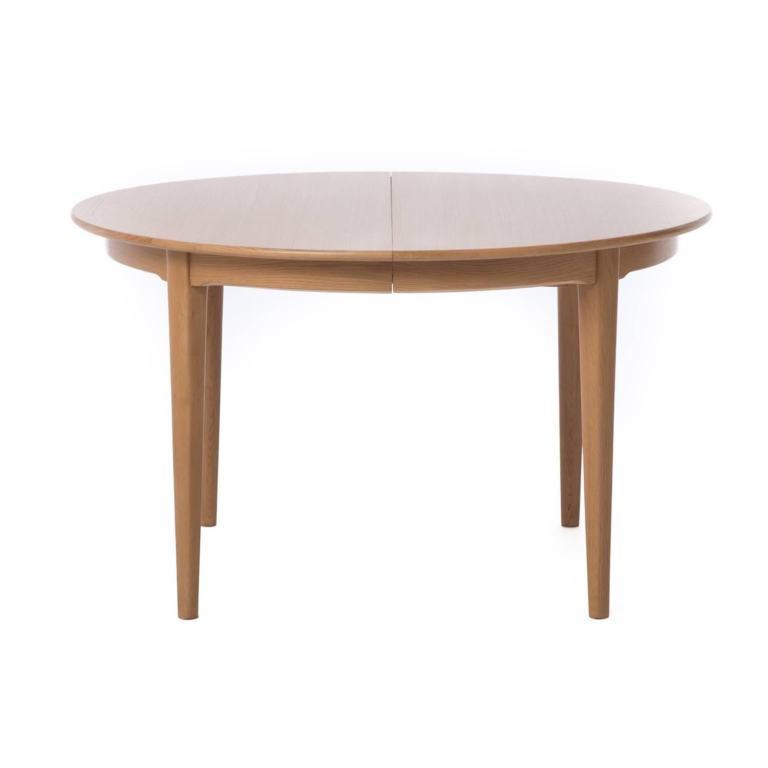 This is an extremely versatile table that is 50" in diameter at its smallest and expands to 117" long to seat 12 people. In a lovely warm white oak. 

Professional, skilled furniture restoration is an integral part of what we do every