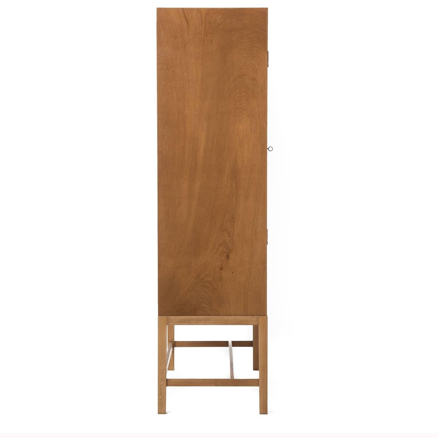 Standing tall at 65" this white oak cabinet provides ample storage. Each inside shelf pulls out for easy accessibility. Non-adjustable. Please inquire for height dimensions between shelves. 

Professional, skilled furniture restoration is an