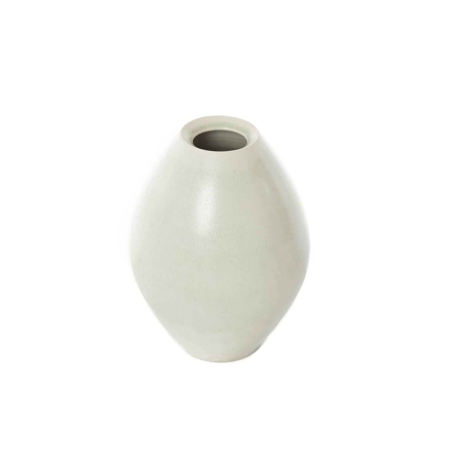 This new item is a glazed heavyweight porcelain vase that is glazed with a pale 'mineral' grey green cast. Signed by the artist. Created by the artist for west shore collection. Appropriate as a stand alone object of art but also usable as a vase