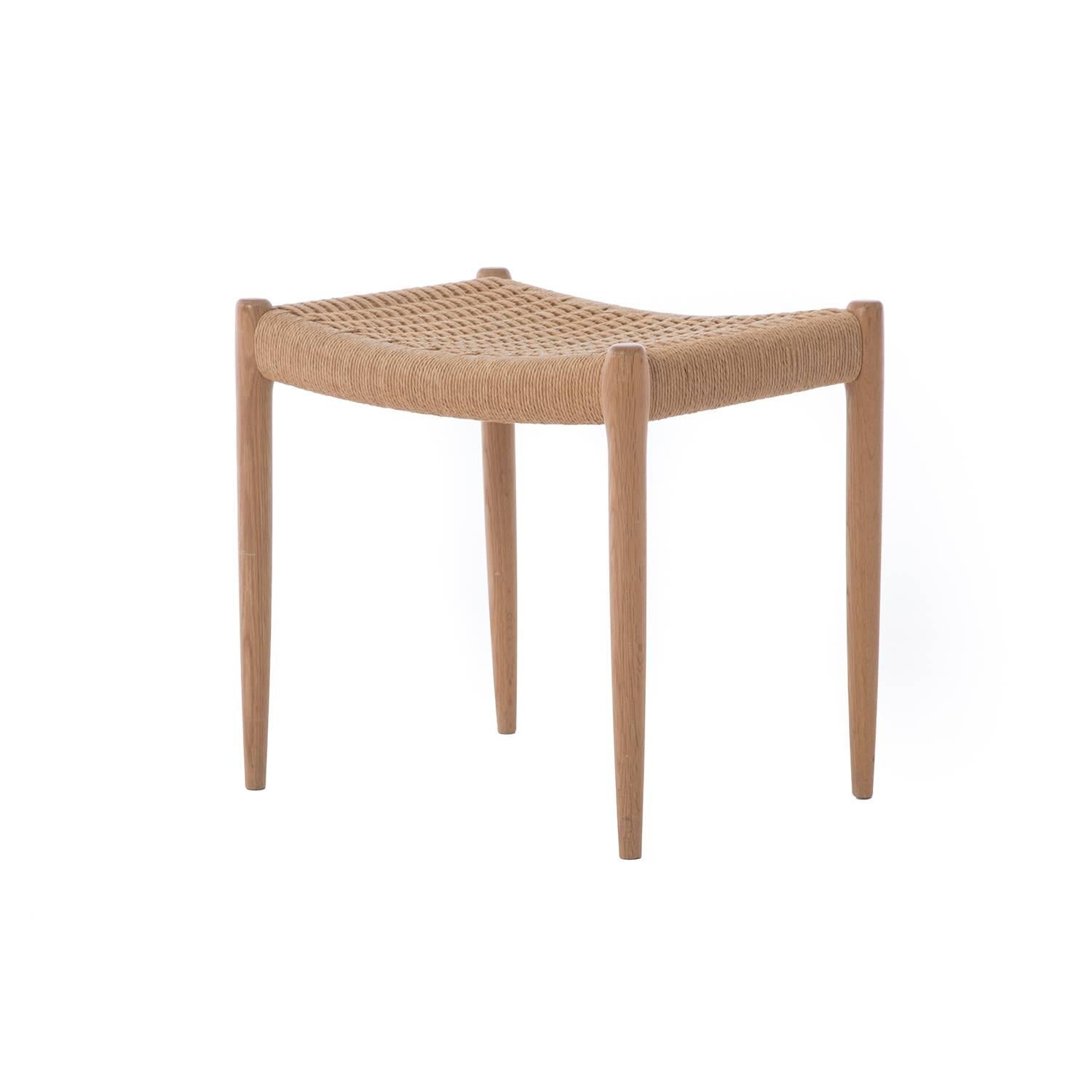 This Danish modern stool is crafted of white oak and retains its original Danish Cord seat. A vintage original.

 