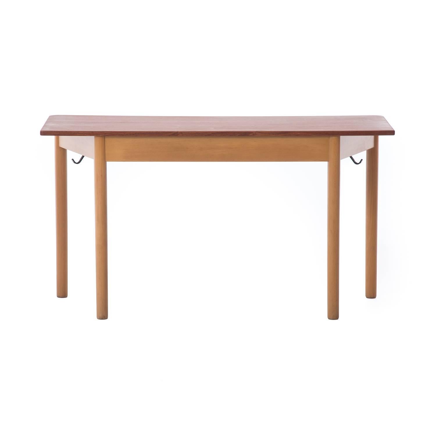This table was designed as a school desk for Danish school children, note the iron book-bag hooks peaking out from underneath (these hooks are removable but they add character to the piece). Front edges of table have a curved detail while back
