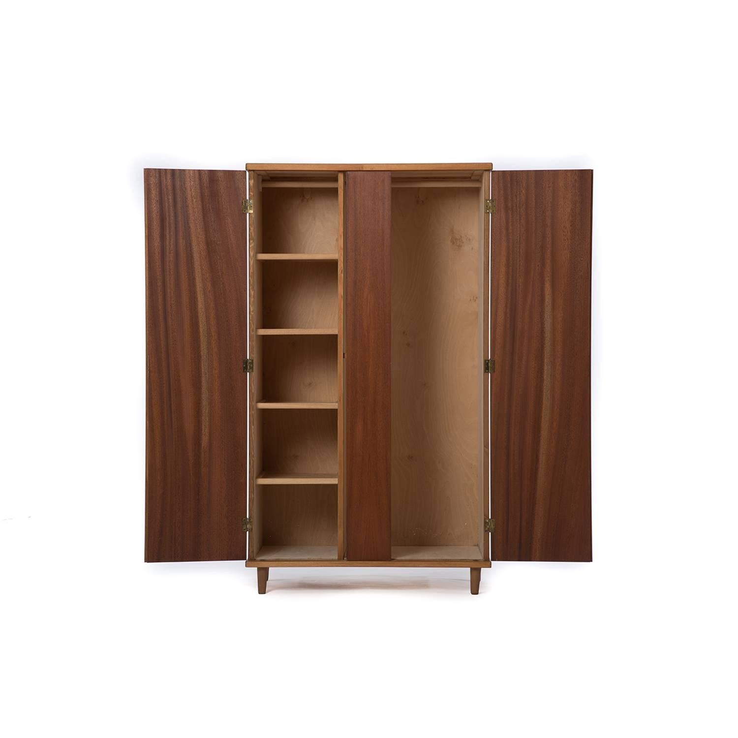 This Classic piece has an old growth teak exterior and a beechwood finished interior with hanging bars in both compartments as well as adjustable/removable shelves in the left compartment. Key locking doors (key included with purchase though not