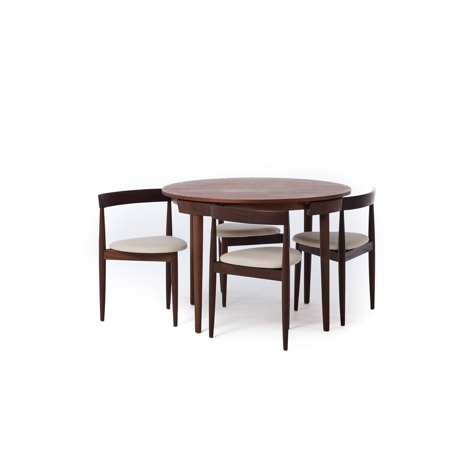 This lovely dinette has four 'disappearing' chairs and a self storing leaf in the centre. The teak has aged to a lovely rich dark tone. Chairs are covered in Danish wool by Kvadrat.
Measures: Table: 42