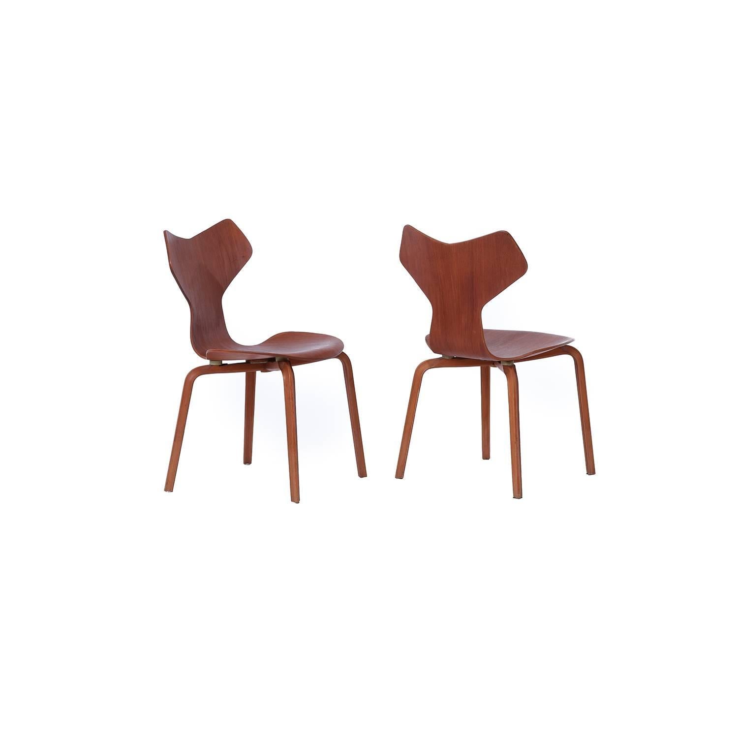 The vintage and beautifully patinated real thing, in teak, designed by Arne Jacobsen produced by Fritz Hansen. These are priced as a set of two, however we are able to sell them by the piece as well.