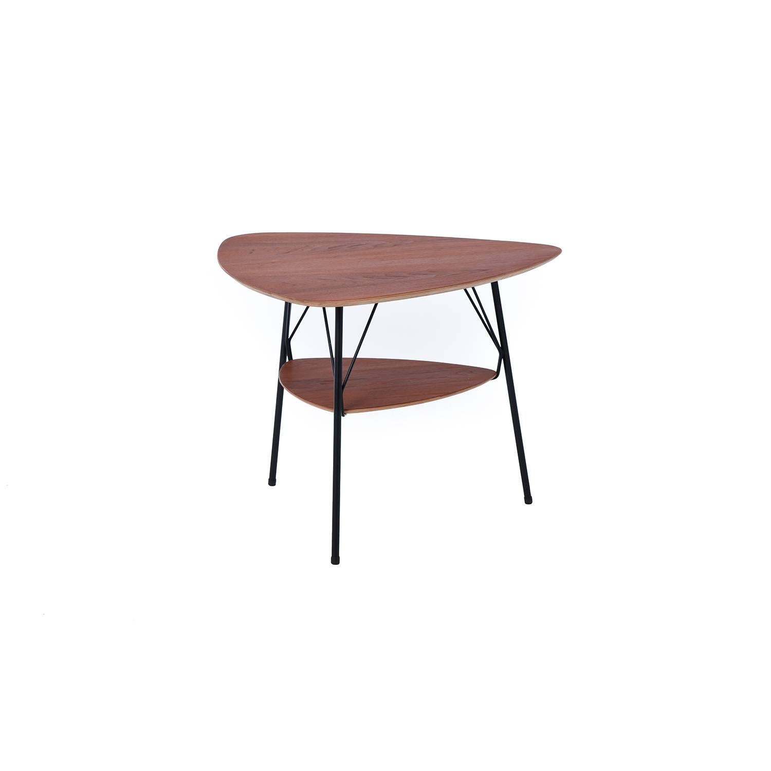 This unique side table features a triangularly shaped top and shelf supported by sleek powder coated black metal legs.