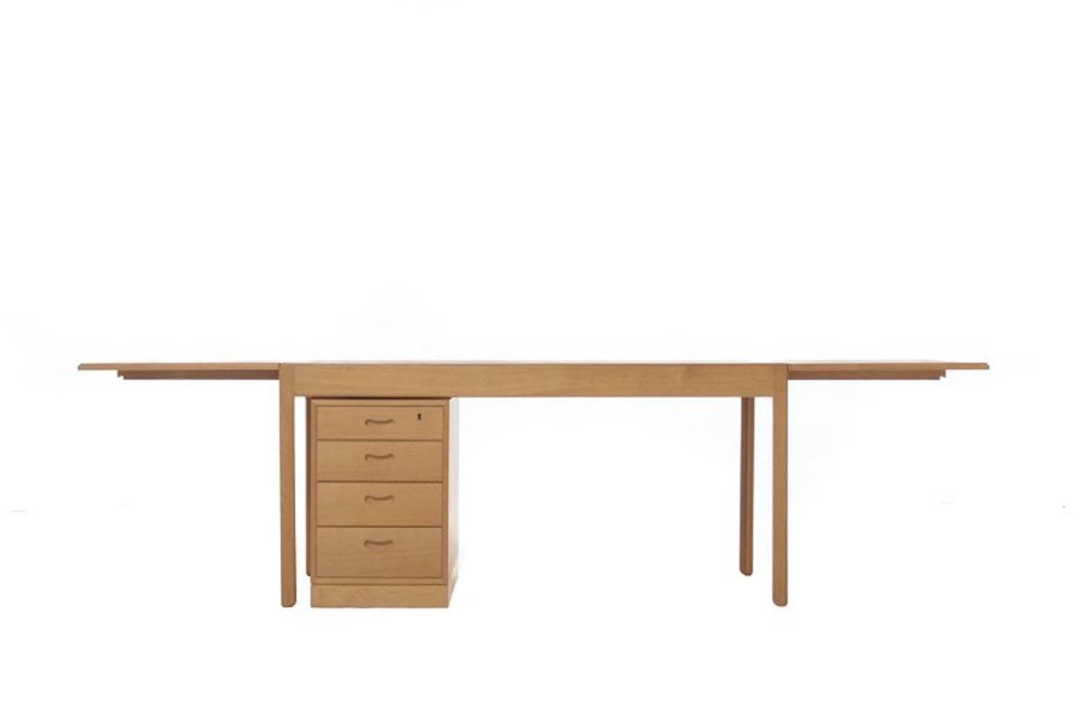 Bernt Peterson designed minimalist drop-leaf office table desk in oak.  This is a substantial and well constructed table finished with spare but elegant details.    Either or both drop leaves can be extended to a full length of 105