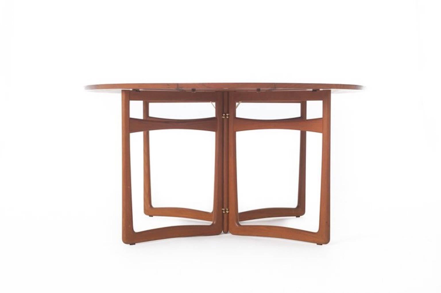 Beautiful gate leg dining table by Peter Hvidt & Orla Molgaard in teak. Leaves down to create console table.