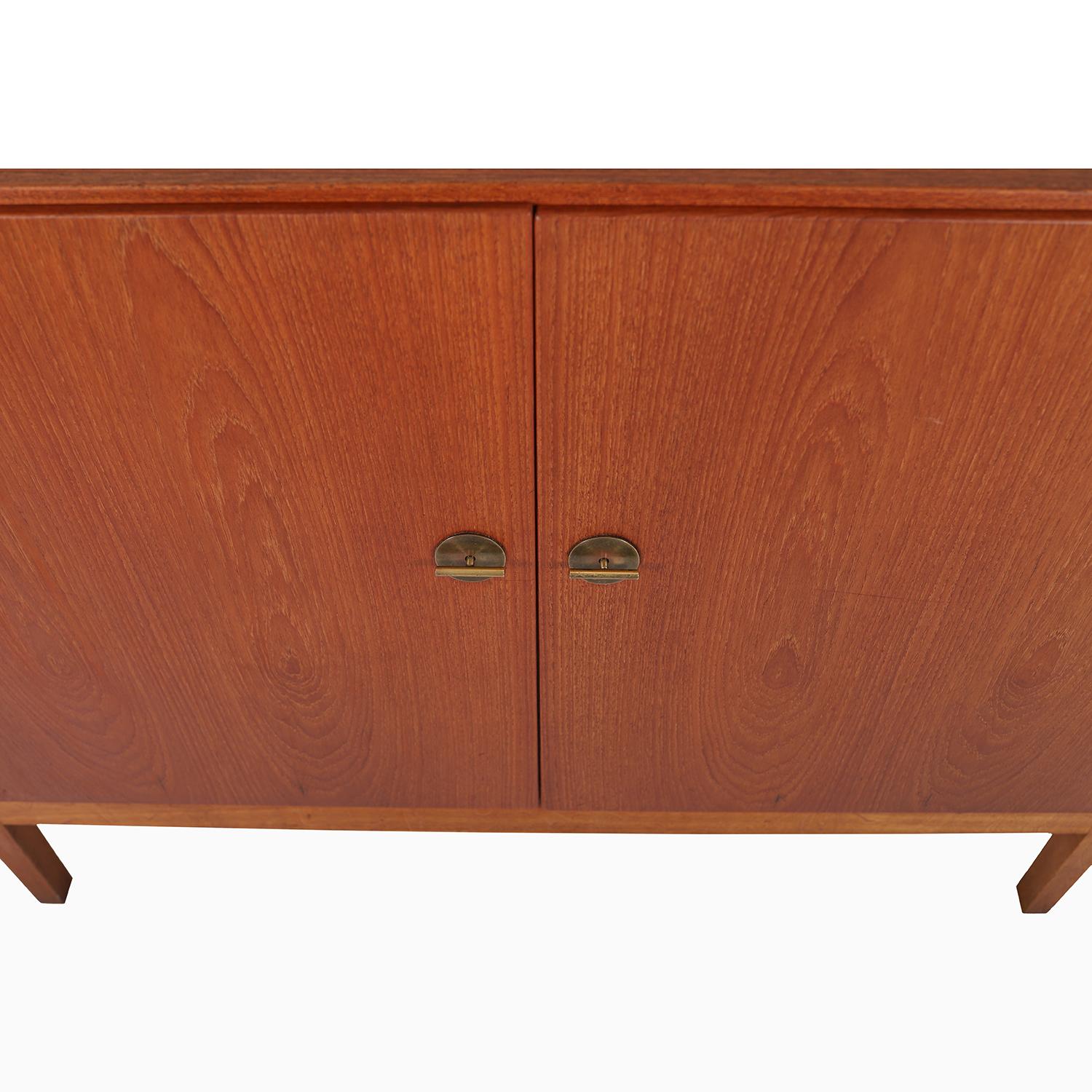 A simple, elegant cabinet designed by Børge Mogensen for CM Madsen cabinetmaker.  Oiled teak exterior with brass handles, lacquered beechwood interior with shelves and pull out organizer drawer.  

Professional, skilled furniture restoration is an