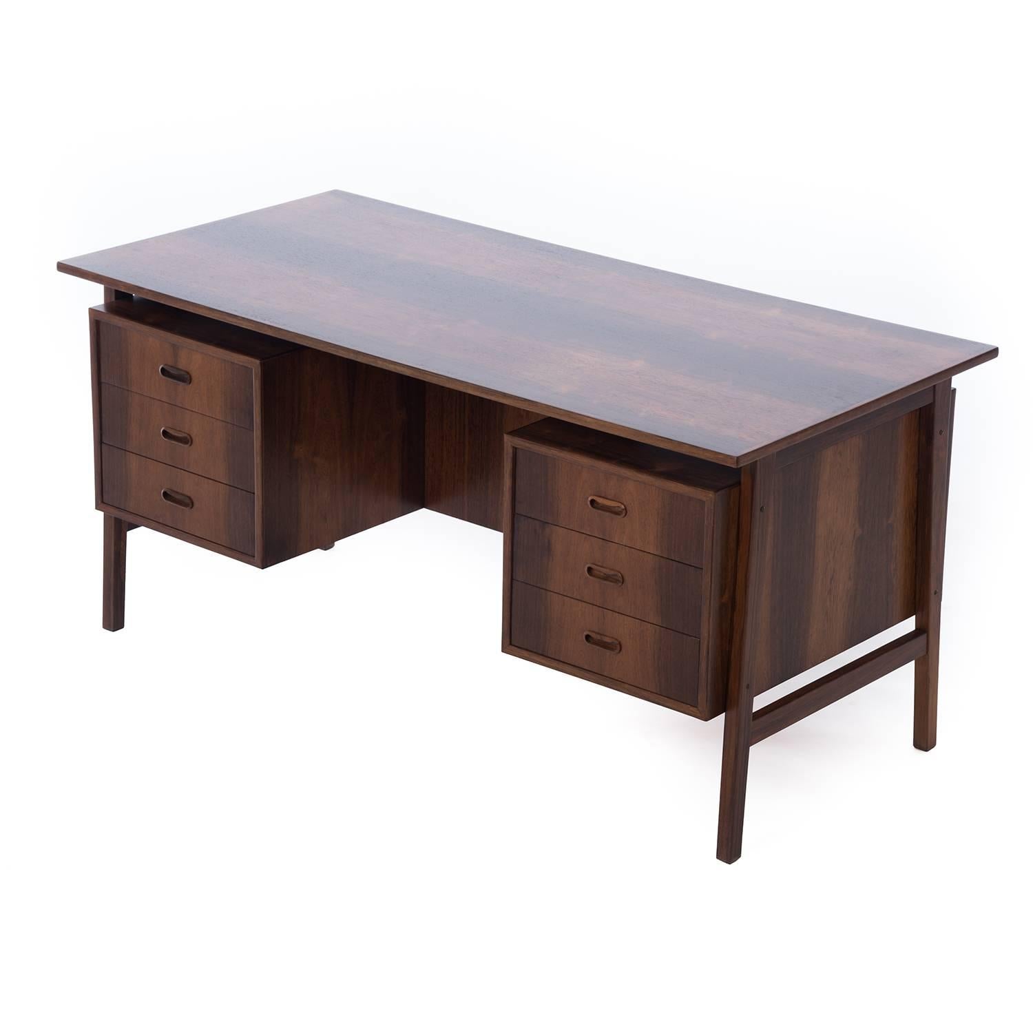 
This is a lovely mid-sized rosewood desk with a floating top and sleek lacquer finish. 
Professional, skilled furniture restoration is an integral part of what we do every day. Our goal is to provide beautiful, functional furniture that honors