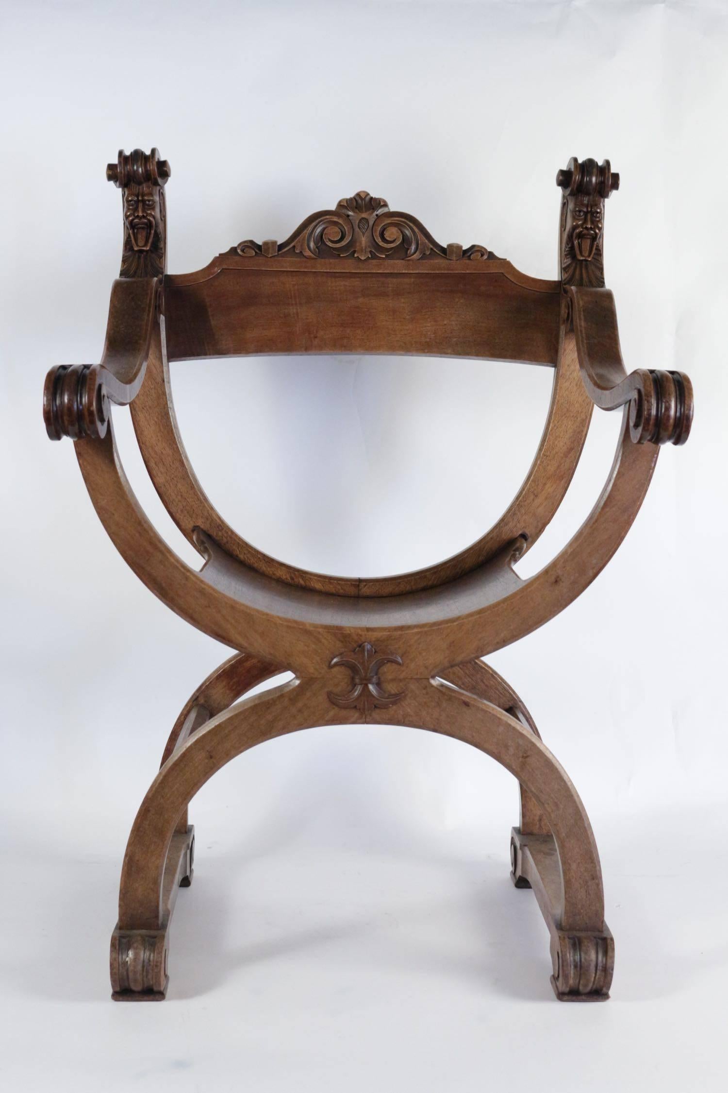 Dagobert or Curule armchair from the end of the 19th century in hand-carved walnut.
 