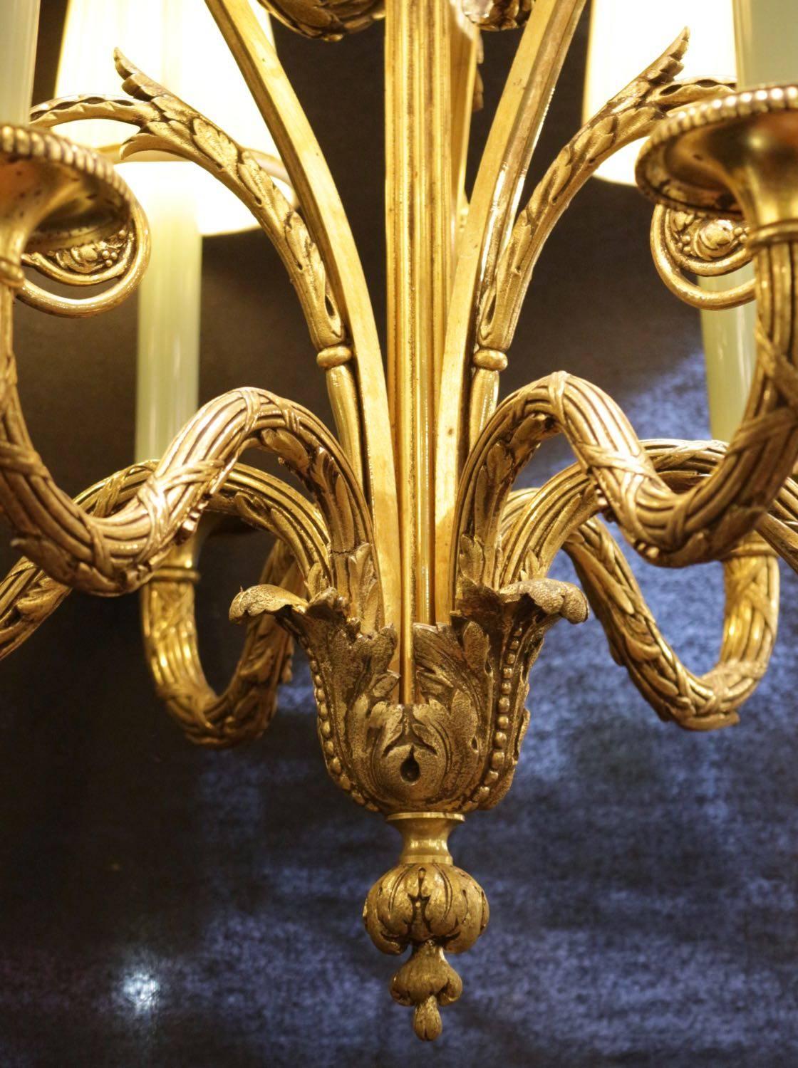 Louis XV style chandelier in gold gilt bronze with its original shades, six arms with beautiful quality hand chiseled bronze, 19th century with candles of opaline glass.
 