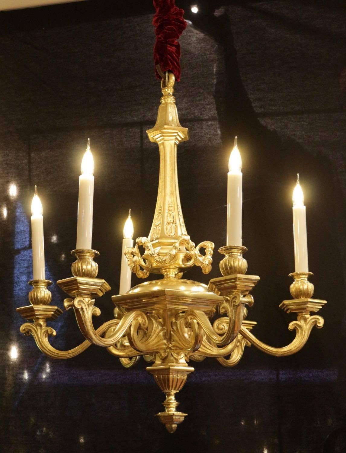 Chandelier from the Napoleon III period in gold gilt bronze from the 19th century, six arms and candles in opaline glass.
 