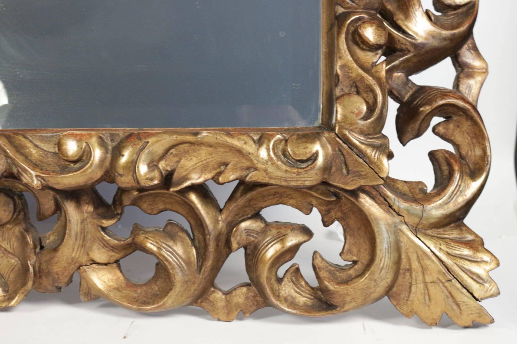 Napoleon III mirror in hand-carved gold gilded wood with bezelled mirror. Measures: L 95cm, H 116cm.
 