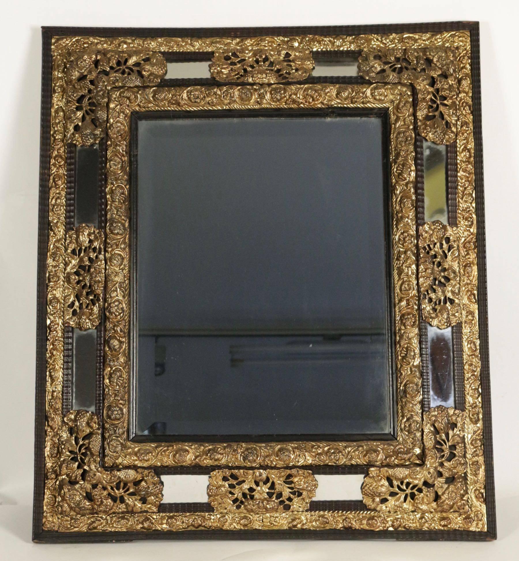 Parclose mirror from the 19th century in gold gilt brass and ebonized wood. Original mercury mirror.
 