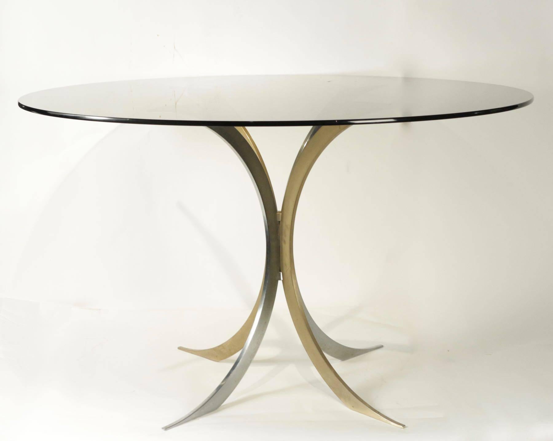 Very pretty table on one foot in chrome metal and gold. Plate glass in tinted smoke color typical of the 1970s.
  