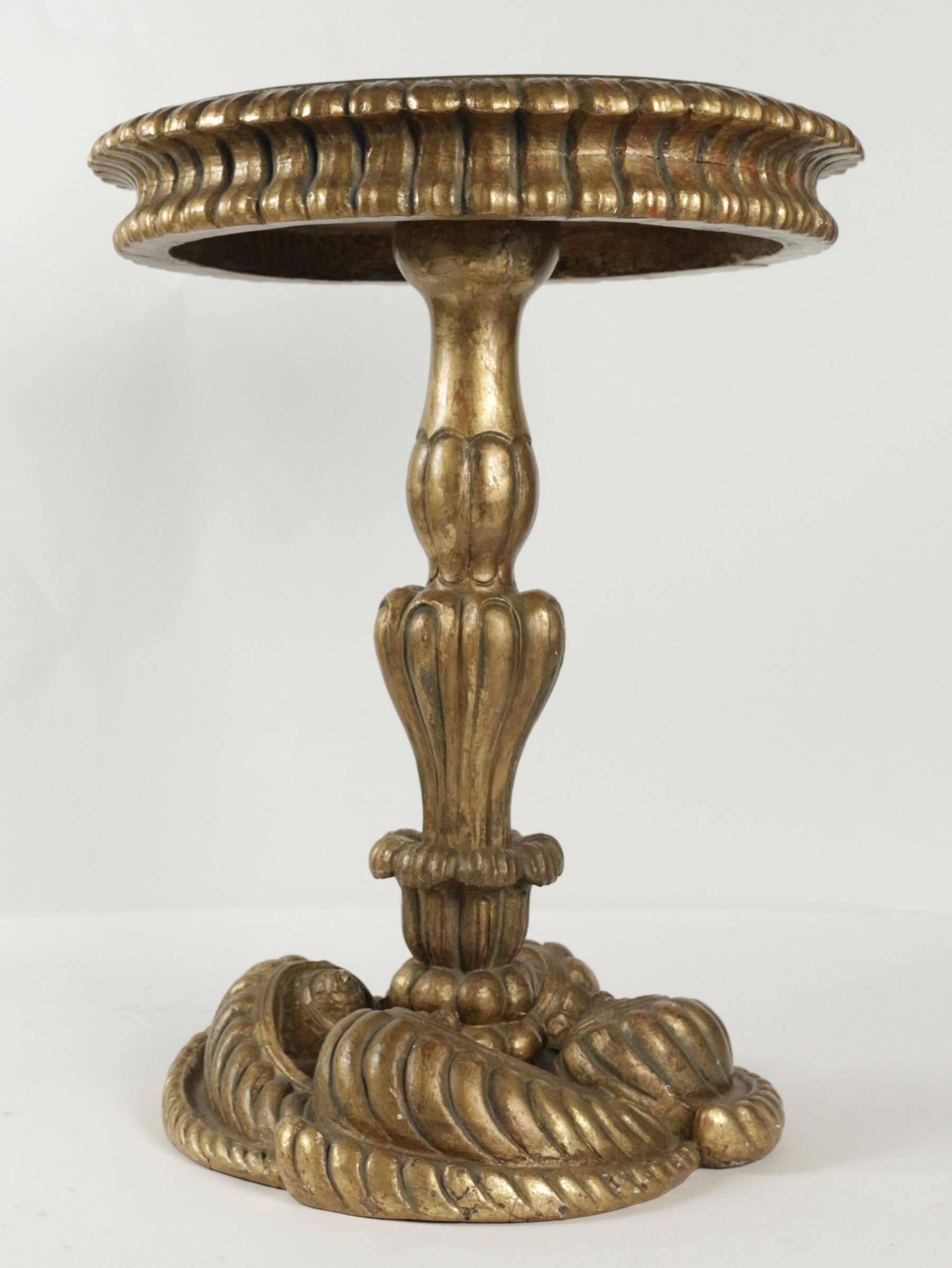 Side table of the early 19th century, base decorated with carved and gilded wooden shells. 
Measures: H 61cm, D 47cm.