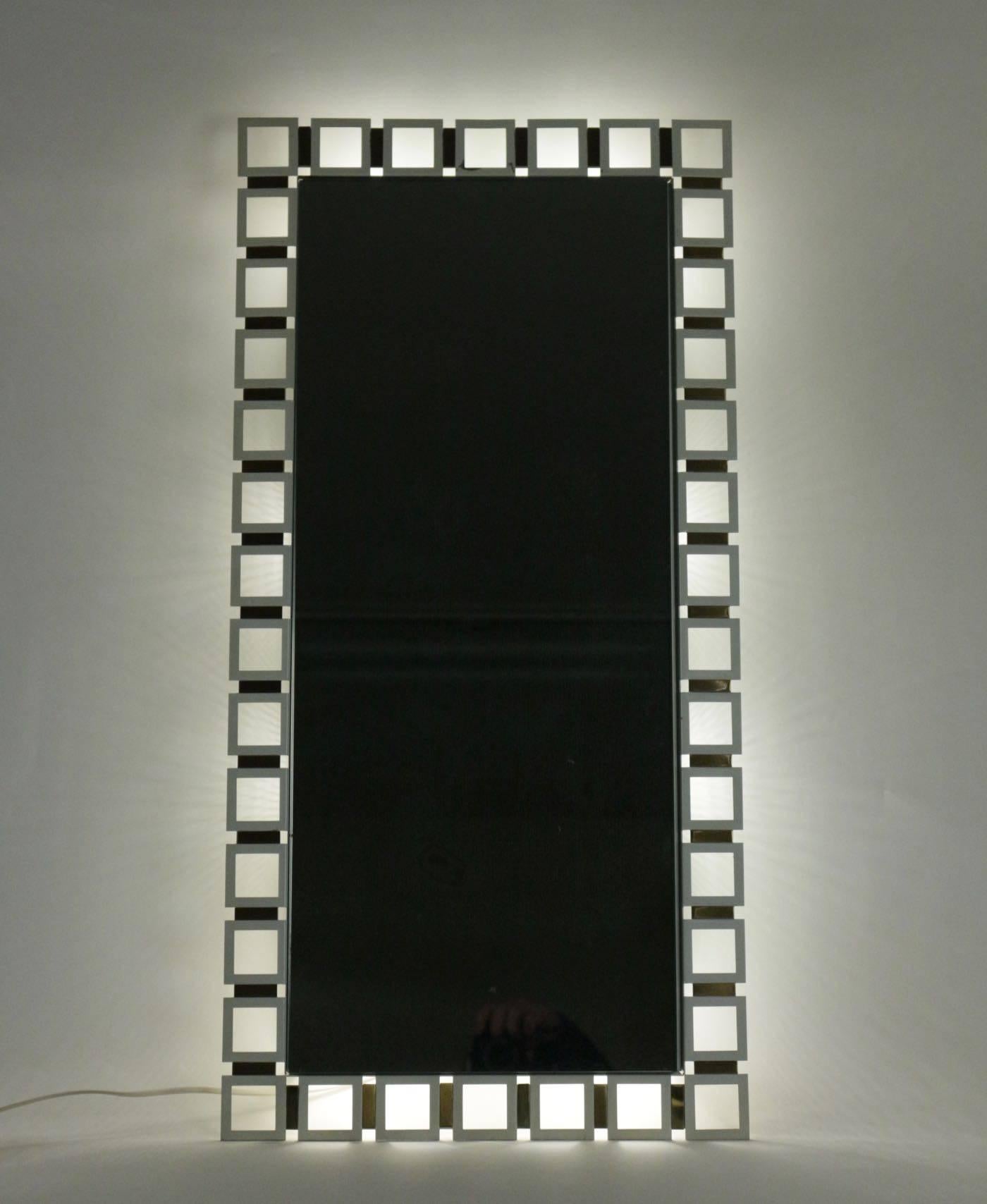 Illuminated rectangular mirror, stainless steel and pewter with white glass, circa 1970.
 