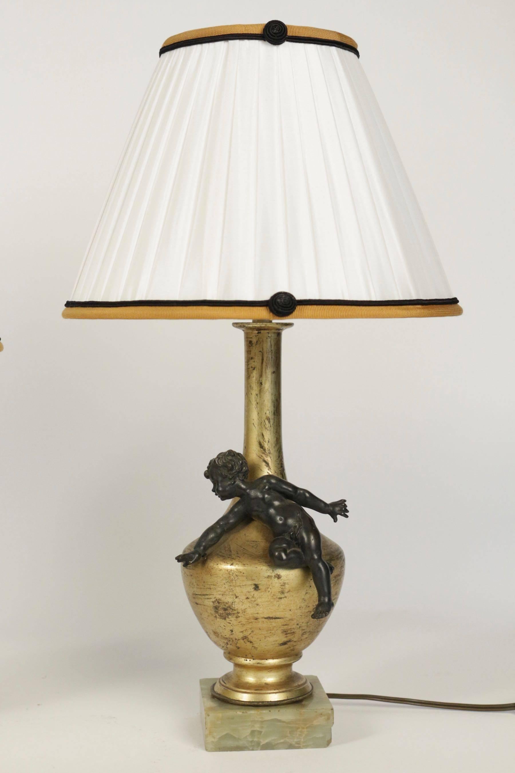 Pair of exceptional matching Napoleon III lamps from the 19th century of two putti in bronze doré on an onyx base.
 