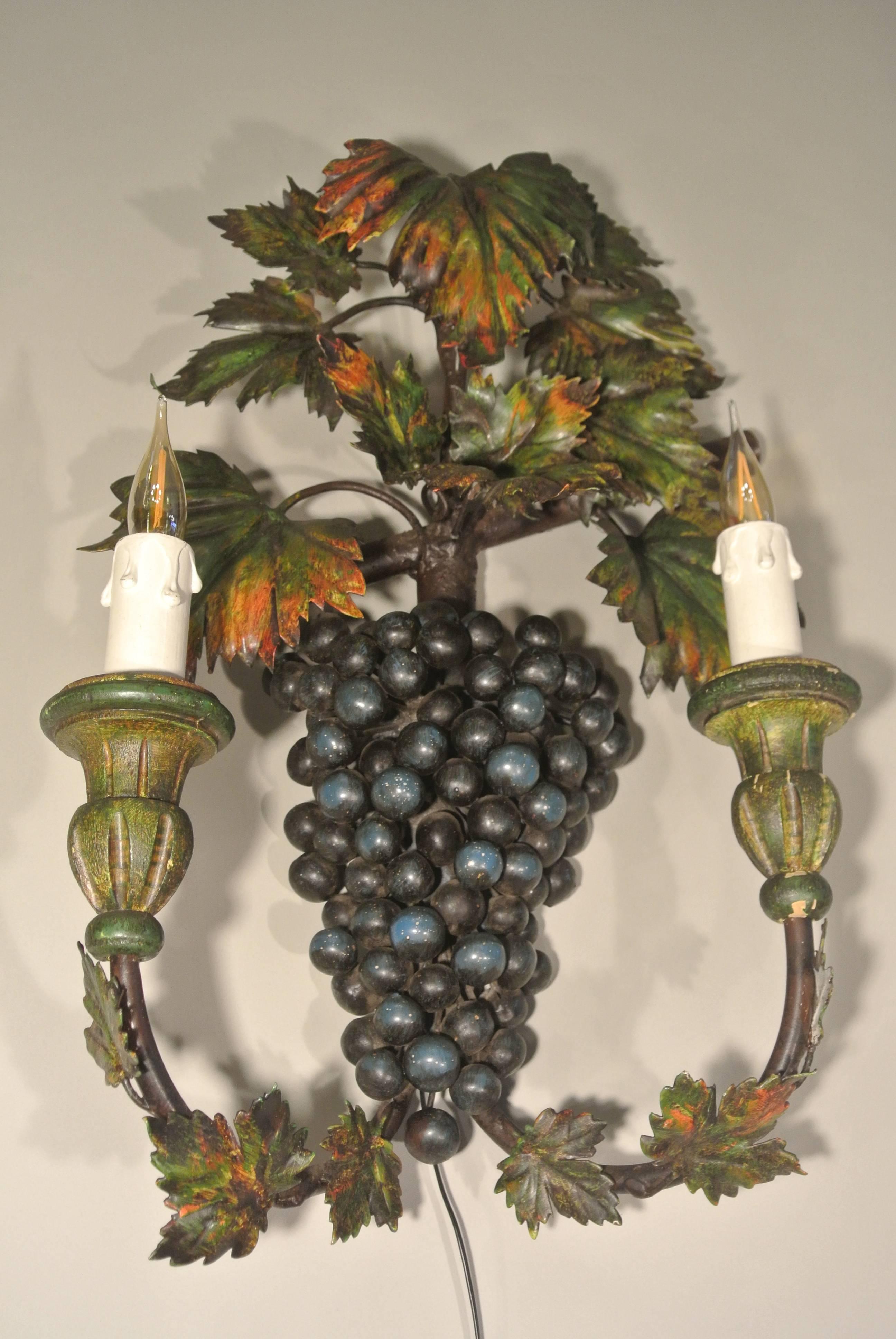 Unusual ‘grapes’ sconce painted with metal and wood paint, circa 1960. Measures: 50cm tall x 29 cm wide x 16cm deep.
 