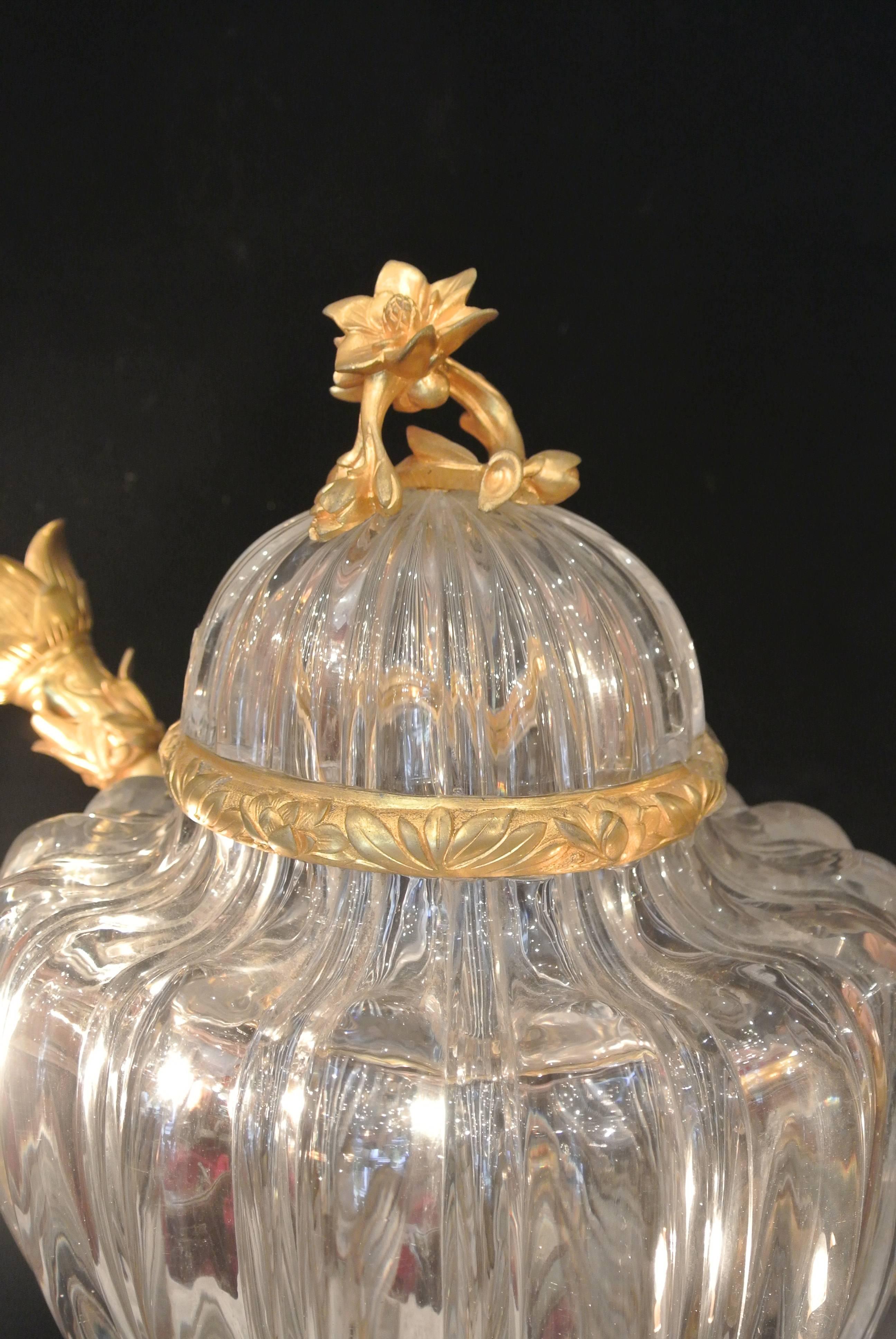 A fabulous center piece of ribbed crystal and gilt bronze. The middle illuminates as well as the arms. Bacarrat Crystal made for the Maison de Crystal. 45cm High x 50cm Wide 