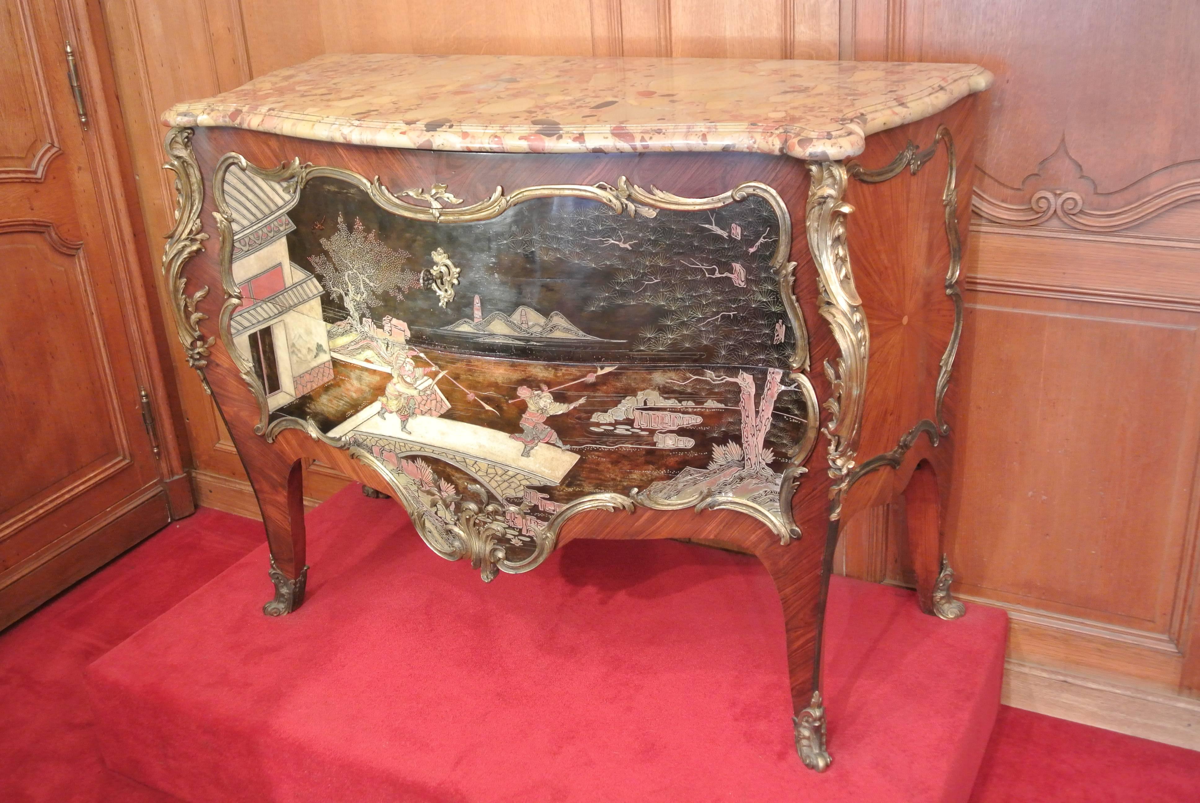 A very fine and rare commode in the style of Louis XV of the 19th Century with two drawers, in violet wood marquetry with very fine bronze mounts and detailing, double edged marble top, with lacquered scene of two Asian warriors. A brass plaque in
