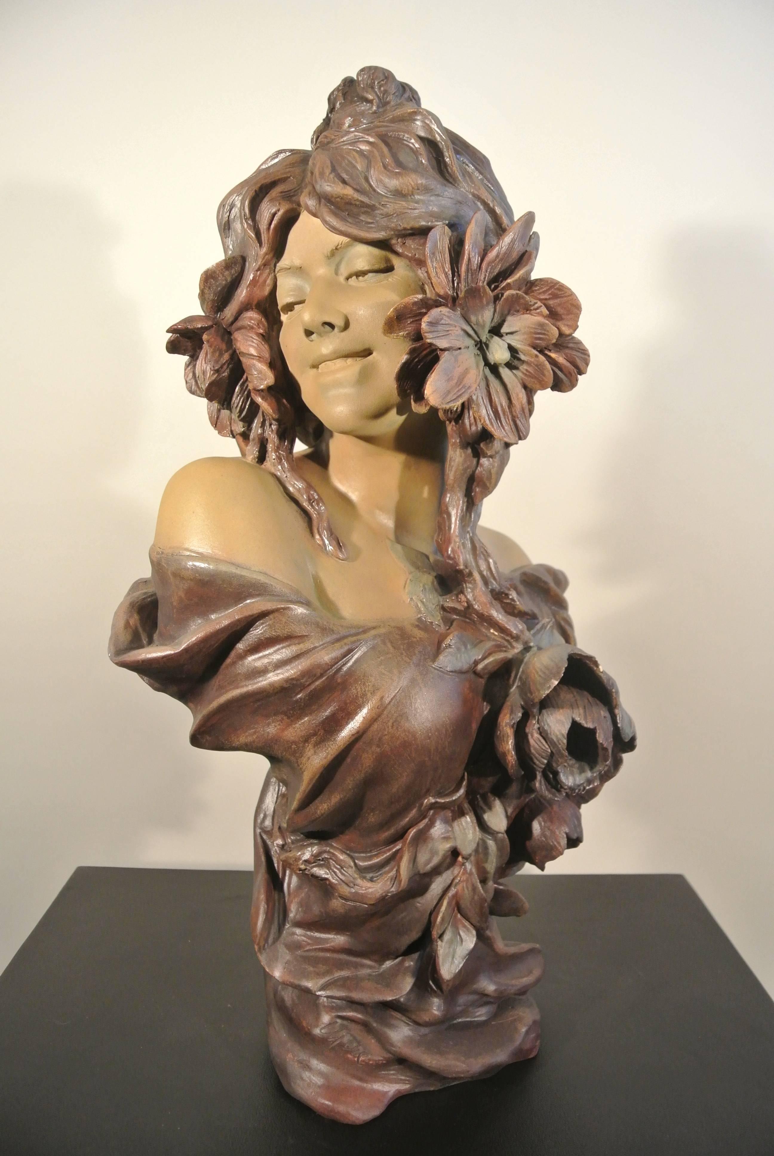 An Art Nouveau terra cotta woman with flowers by Goldsheider, circa 1900. Measures: 50cm x 27cm x 21cm.
 