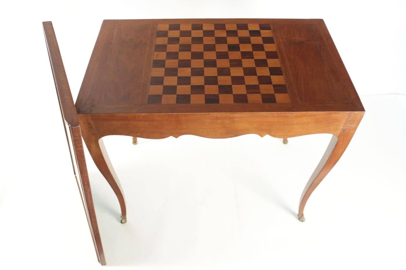 Writing desk and games table 19th century with leather top removable top covering a checker board. Two drawers.
 