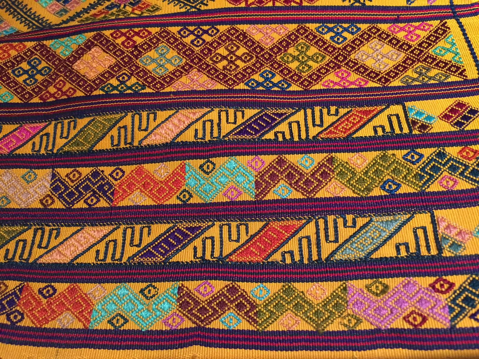 From the royal weavers of Bhutan, this kira textile is a rectangular weaving worn as an ankle length dress by Bhutanese women. This example was originally woven for Her Majesty Gyalyum (Queen Mother) Sangay Choden Wangchuck, who founded the Royal