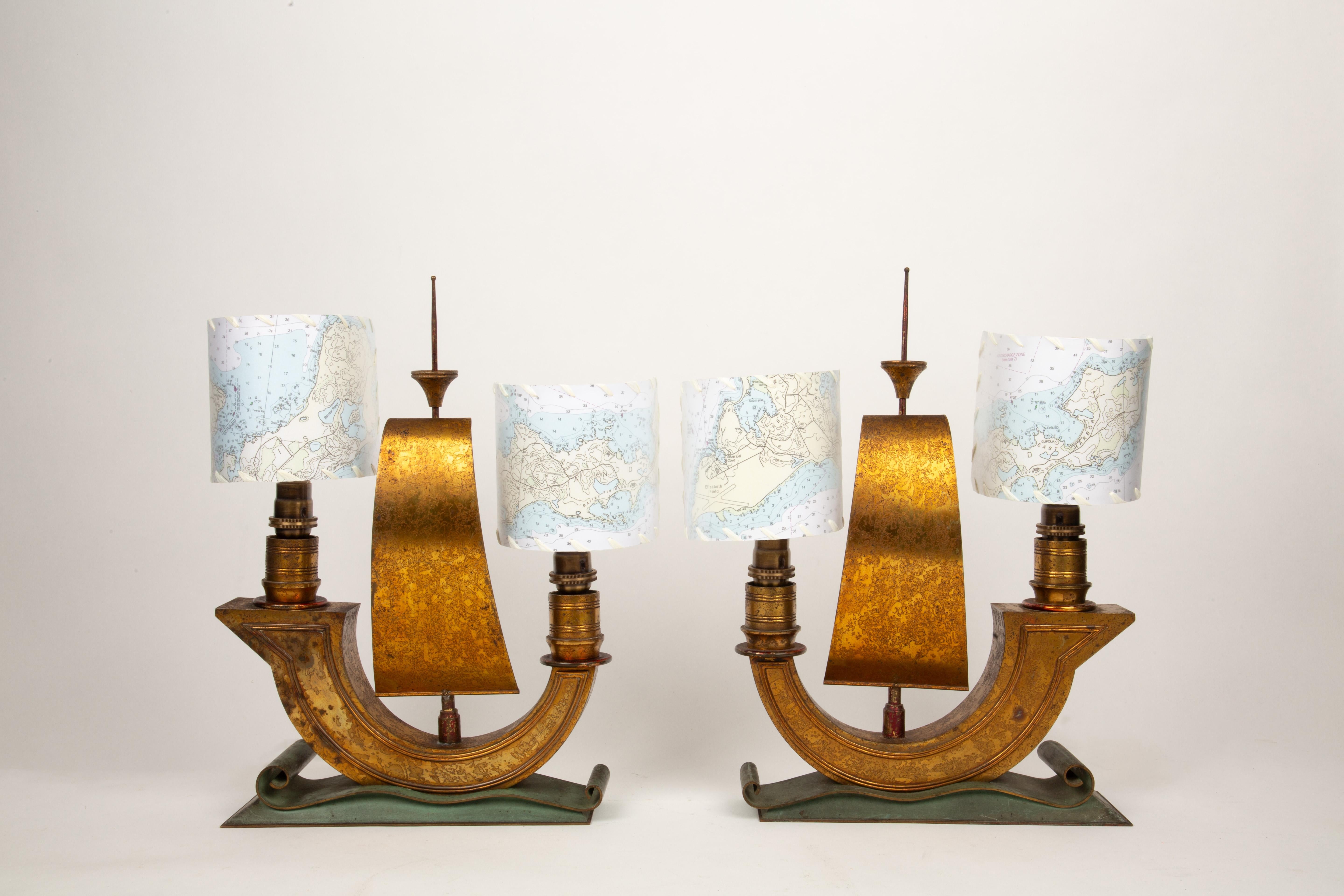 This exceptional pair of Art Déco table lamps, crafted in the form of stylized galleon ships, showcases the elegance and craftsmanship of 1940s French design. Attributed to the renowned French metalworker Raymond Subes, these lamps feature a