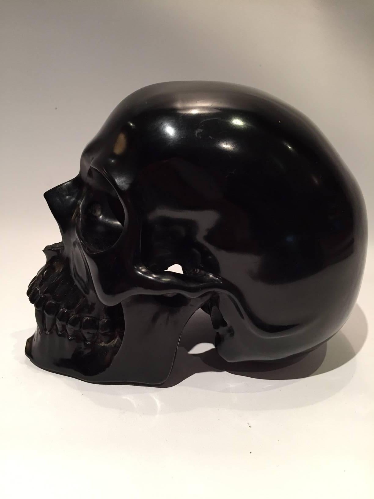 Russian jet fossil carving of a Human Skull, half life-sized.  Jet is a semi-precious ornamental stone, an ancient fossil, formed from petrified plant and organic matter. This is an exceptional example in that is the largest jet carving we have ever