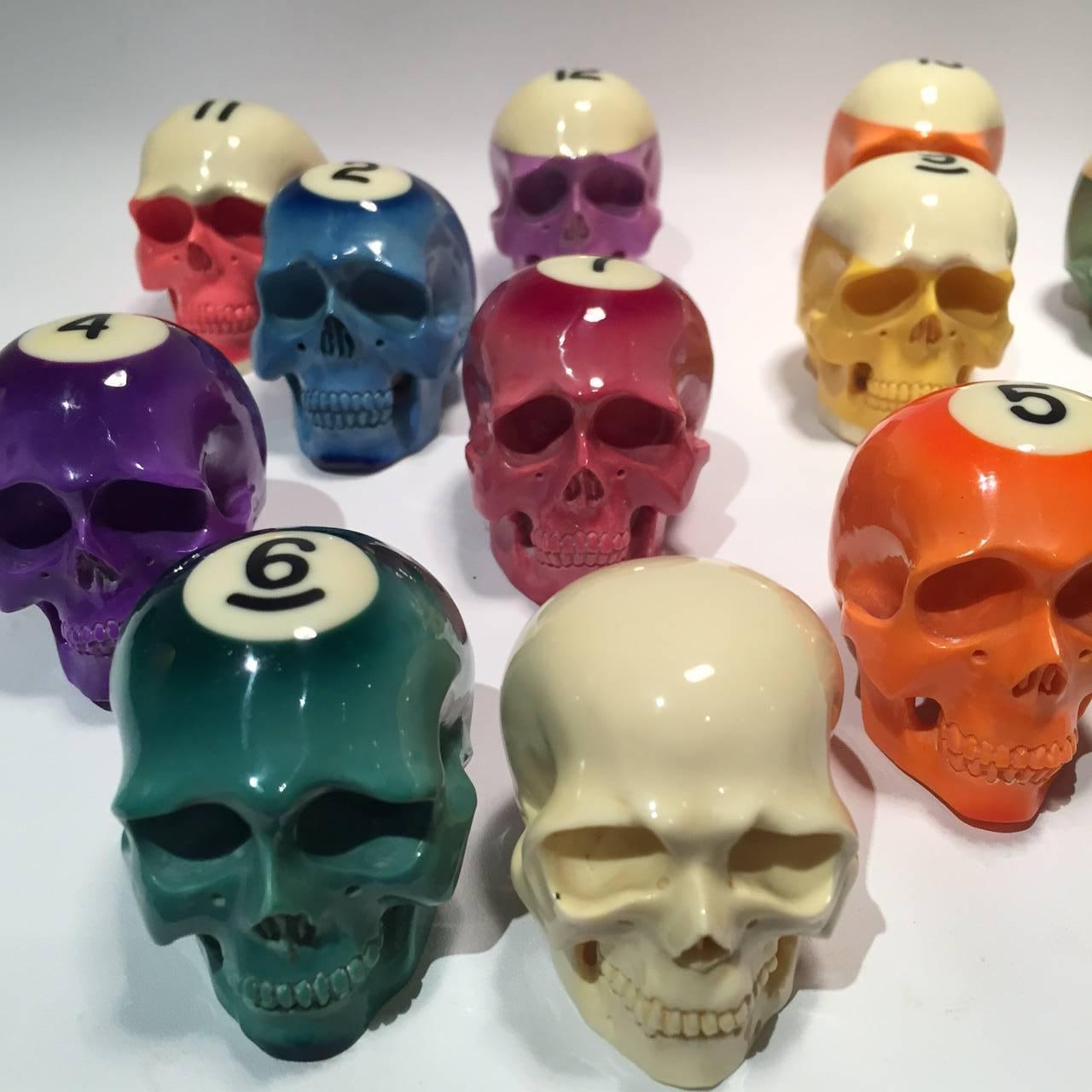 Billiard ball skull set, carved in Indonesia. This is a complete set of vintage Bakelite pool balls, including the cue ball, that have been recently hand-carved in the shape of skulls. A great gift for any billiard enthusiast.