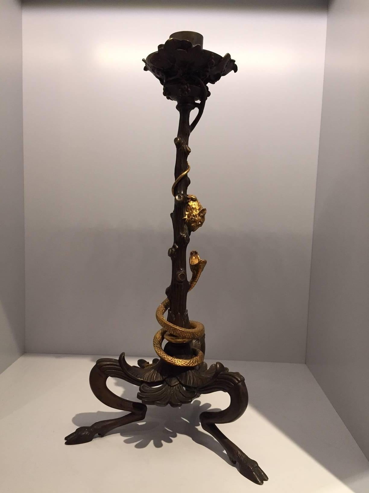 Beautiful pair of bronze Victor Paillard style candle sticks with intertwining gilded snakes and mice climbing a bacchanalian vine. Mounted on a classical hoofed tripod base with acanthus leaves. Marked- V. Paillard.