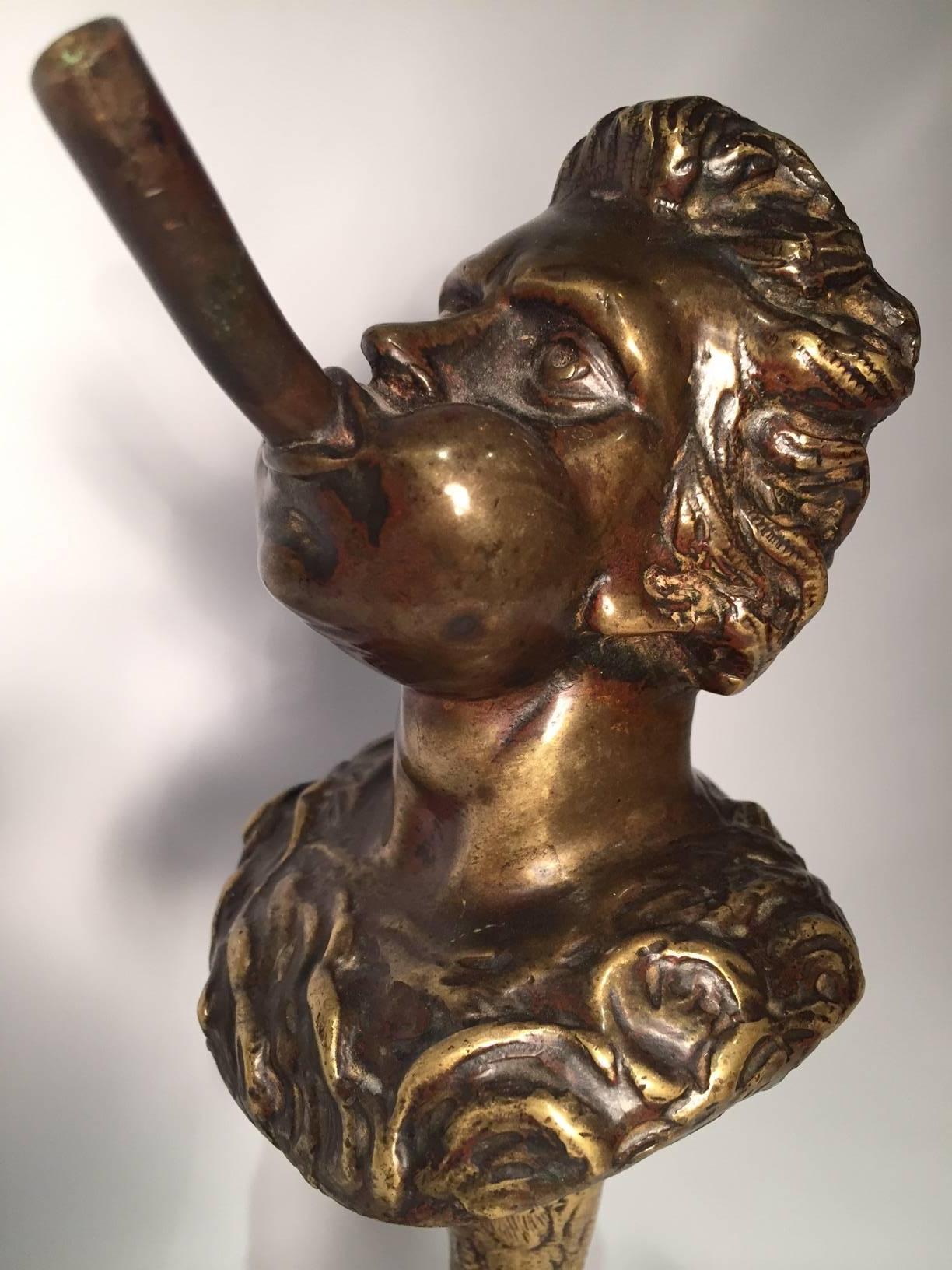 Very unusual 19th century Continental bronze tobacco cigar lighter. The beautifully cast head, smoking a cigar, is mounted on a bird claw. There is a reservoir that can be filled with oil through a hinged portion at the top. A wick can come out of