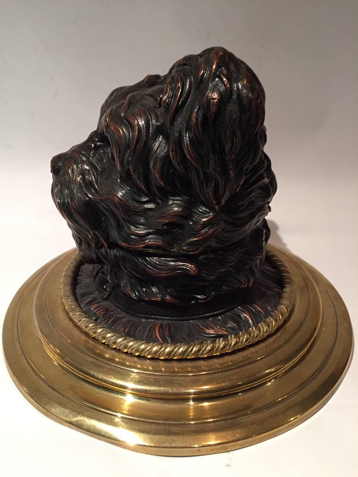 Very detailed late 19th early 20th Century  French inkwell of a Yorkshire terrier dog with the original ceramic ink vessel, mounted on a brass base.