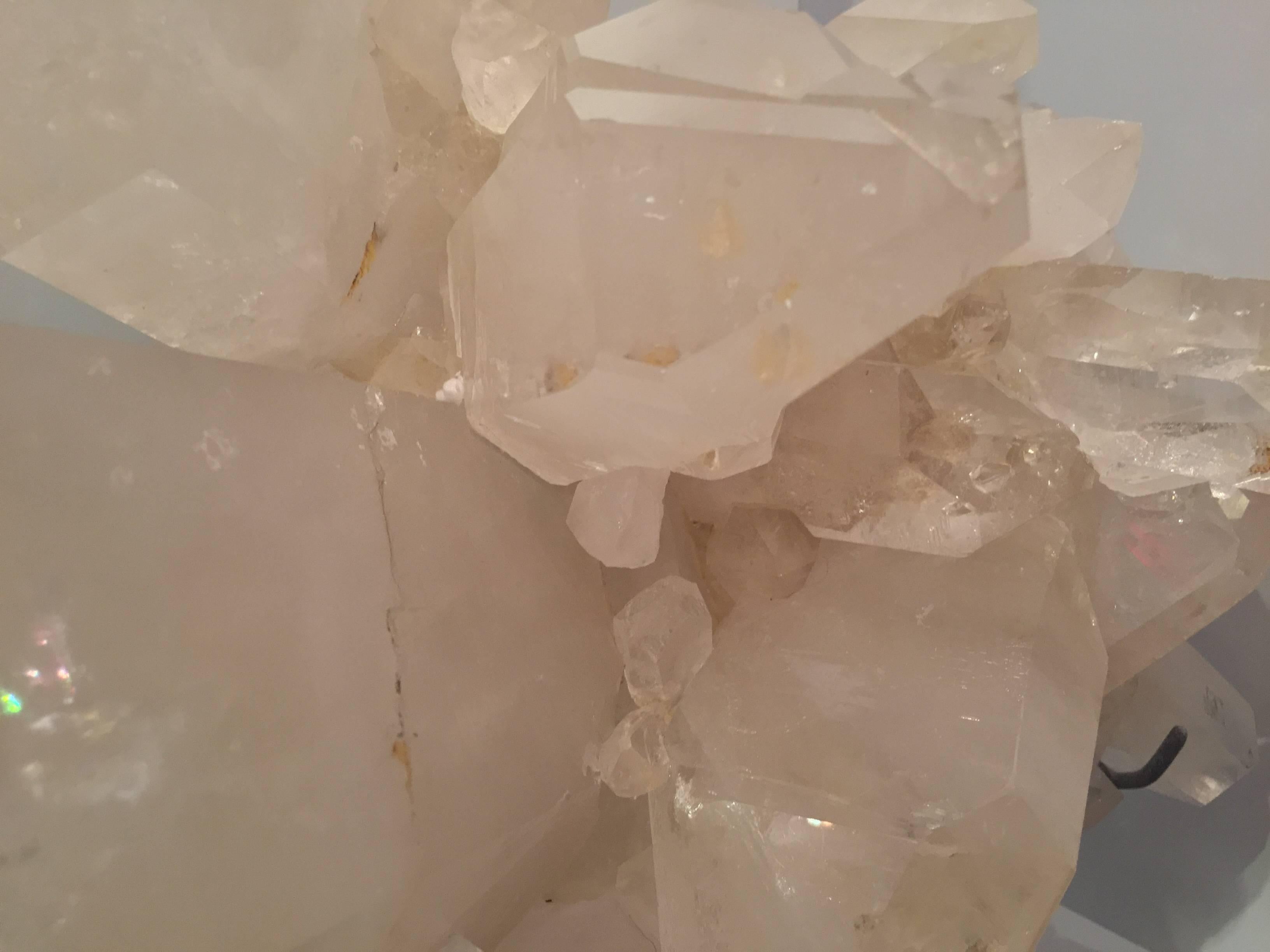 Large rock crystal quartz cluster mined in Brazil and custom mounted on a black painted metal base.

The many properties of rock crystals are well-known and include the balancing and revitalization of physical, mental and emotional needs.

Rock