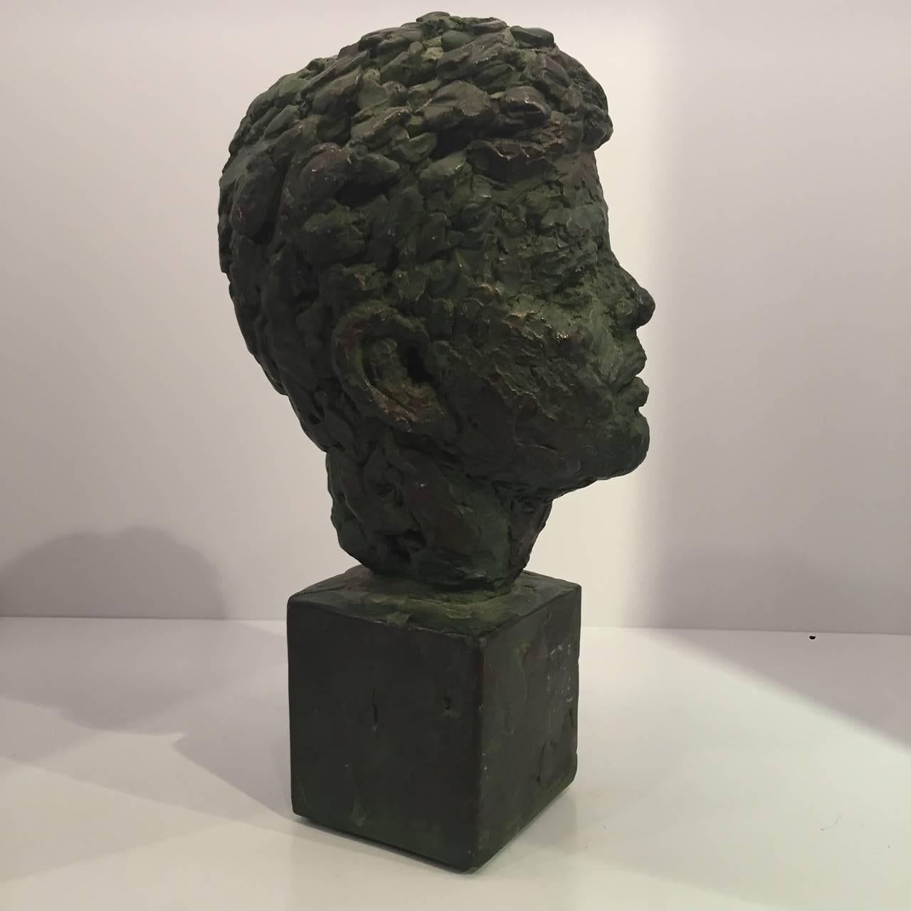 Bust of former President John Fitzgerald Kennedy made of bronze-patinated plaster by Robert Berks, American sculptor (1922-2011).
It bears the artist's signature 