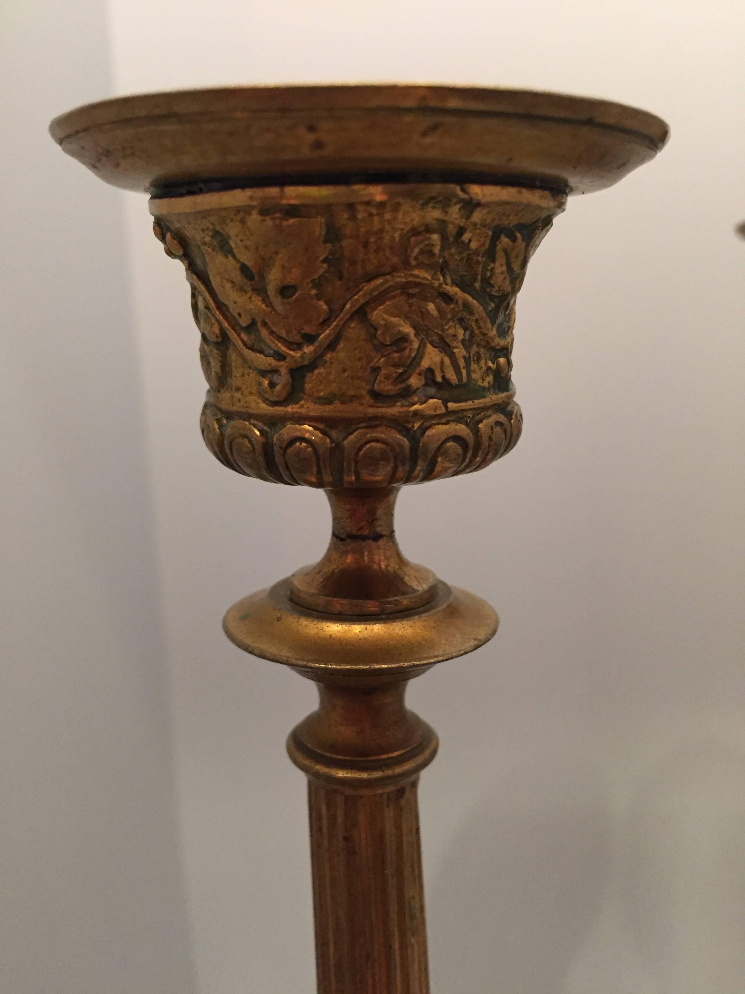 Beautiful pair of bronze Victor Paillard style French 19th century candlesticks each with a snake climbing down a reeded stem supported by a tripod base consisting of lion paws and acanthus leaves. The upper part is decorated with a bacchanalian