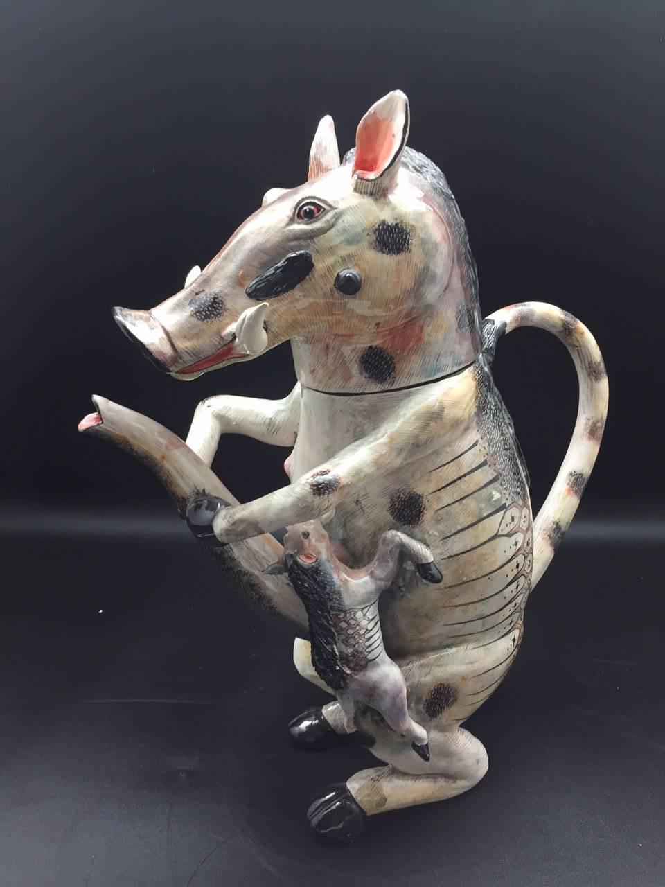 Shemale Warthog teapot AAA, ceramic by Ardmore from South Africa. Sculpted by Sfiso Mvelase, painted by Roux Gwala 6" x 12" x 13 1/2" H.

Ardmore ceramic art was established by Fée Halsted and is situated in the foothills of the