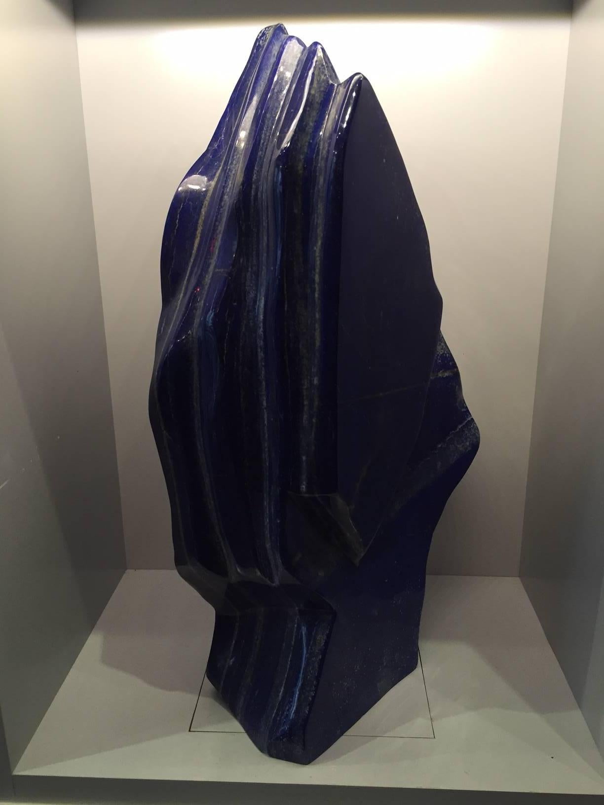 Very large polished lapis lazuli mineral specimen from Afghanistan, free standing and weighing 85 lbs. This semi-precious stone has been prized since antiquity due to its intense, beautiful blue coloring and golden speckles. It was also used in the