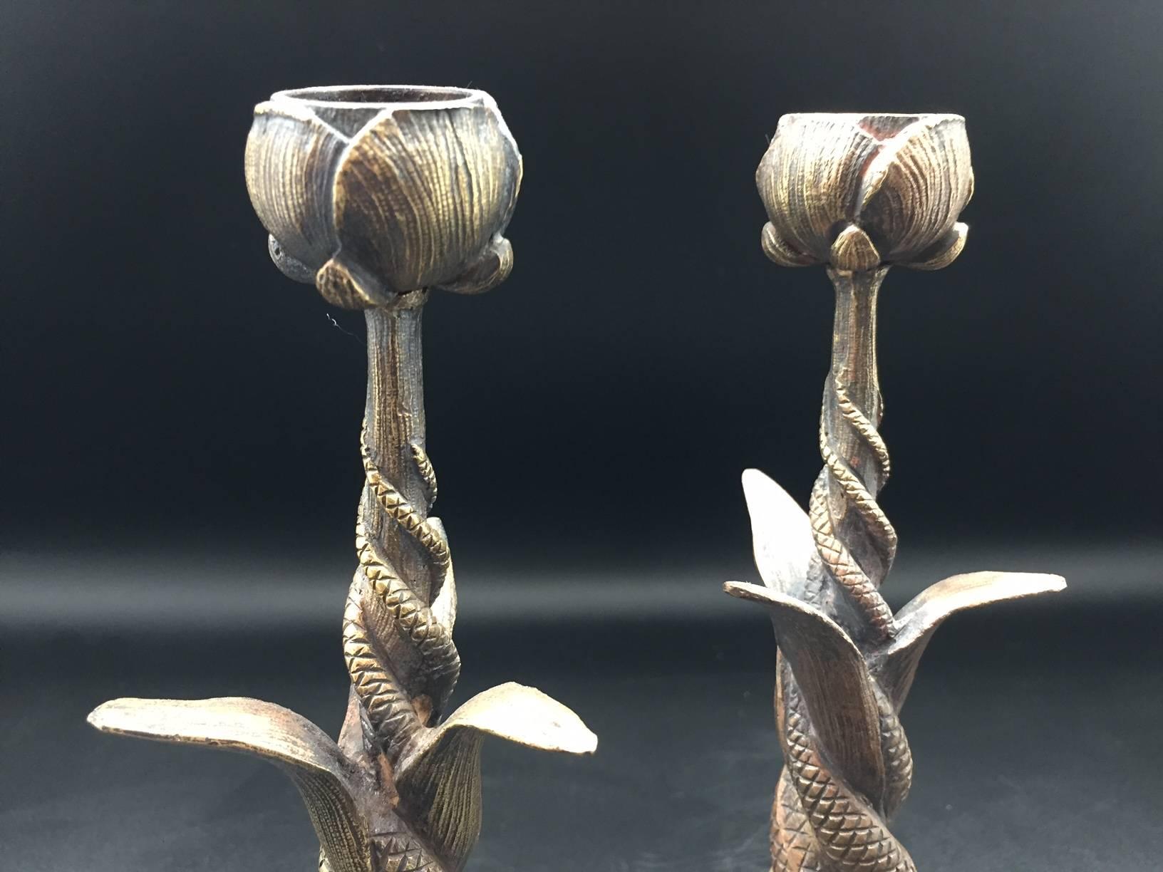 Pair of French Art Nouveau serpent and poppy flower bronze tripod candlesticks. The intertwined stylized poppy flower, leaves, and serpents are typical motifs from the Art Nouveau period, and possibly inspired by the Egyptian iconography of that