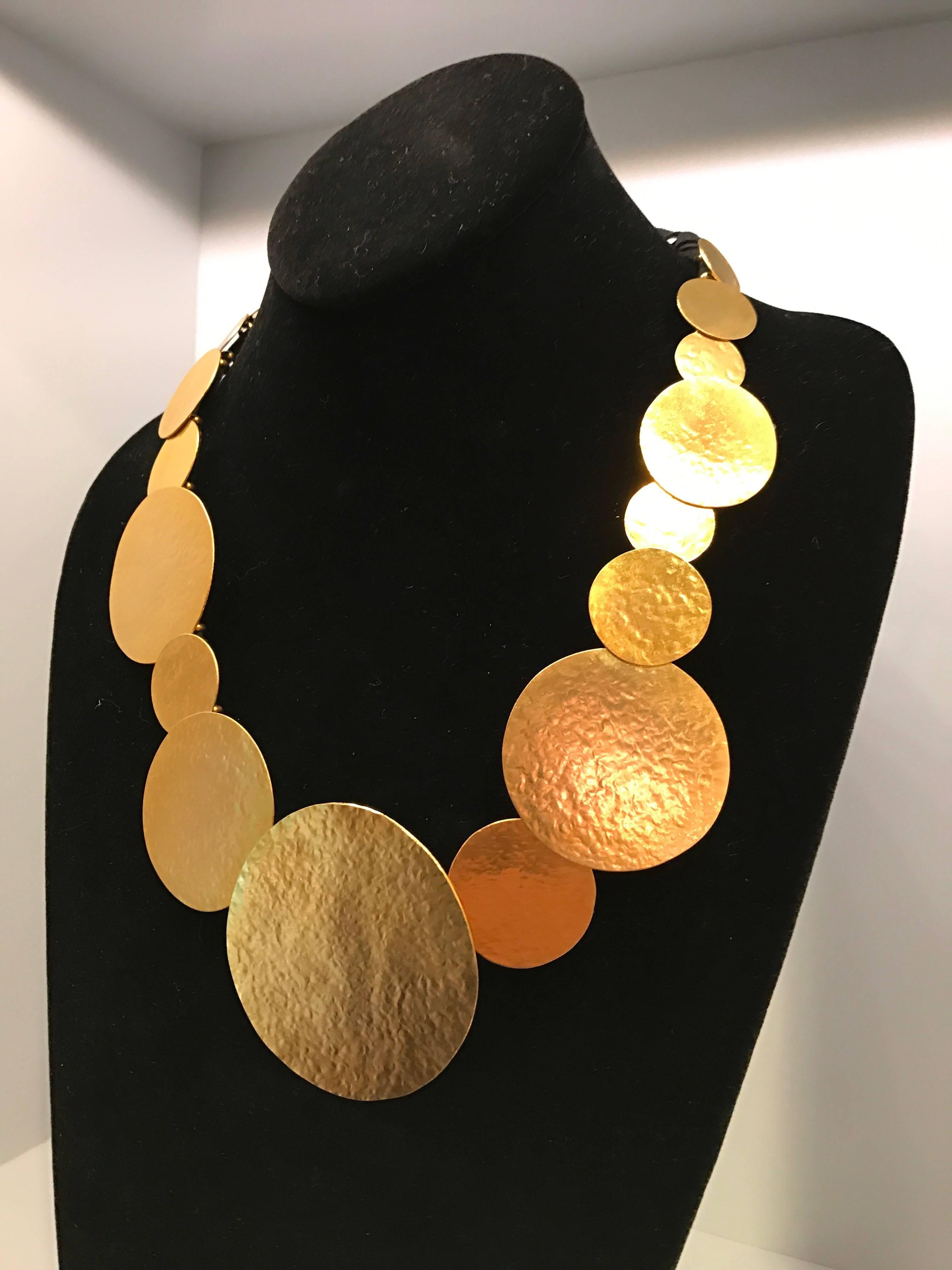 Hand-forged brass and 24-carat gilded pastilles necklace by the French designer Herve Van Der Straeten with an adjustable black suede ribbon, the artist's HV hallmark and his custom jewelry pouch.