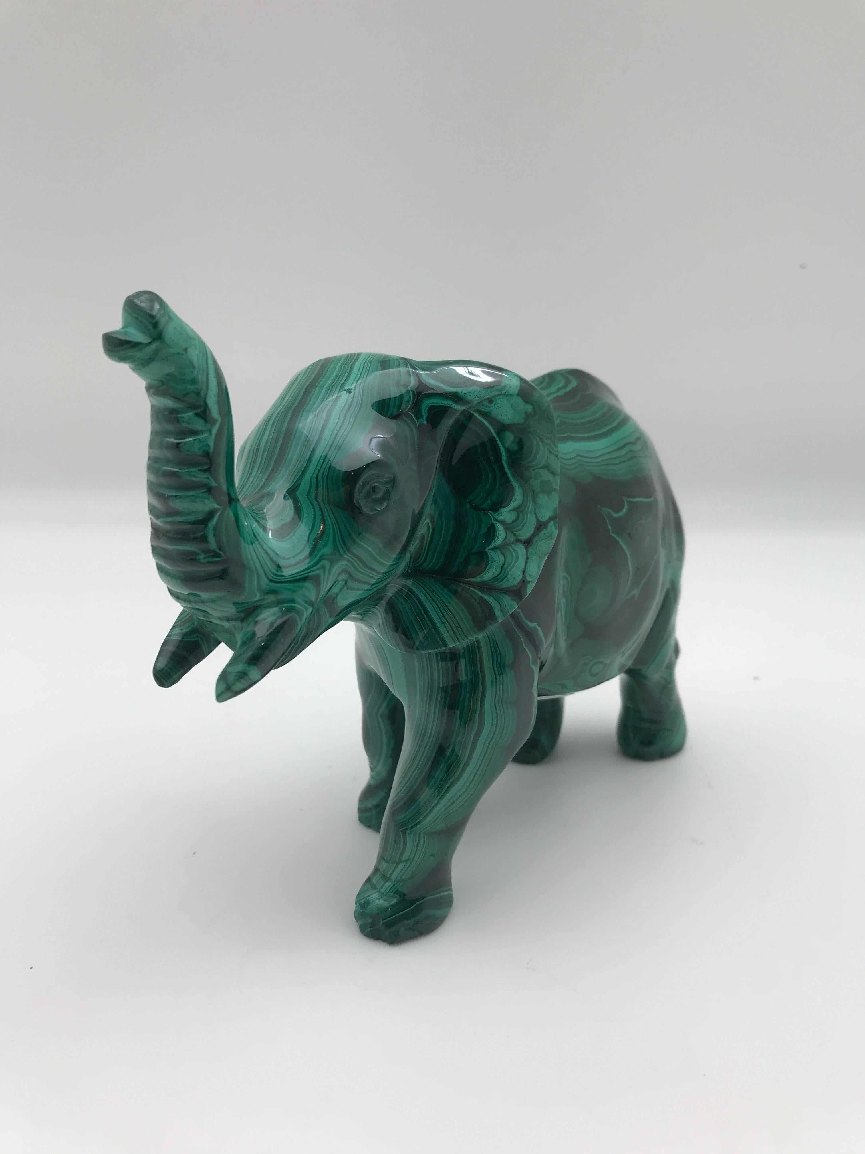 Very large carved Malachite elephant with its trunk up- to bring good luck. This piece was hand-carved in India out of one solid piece of malachite from the Congo.