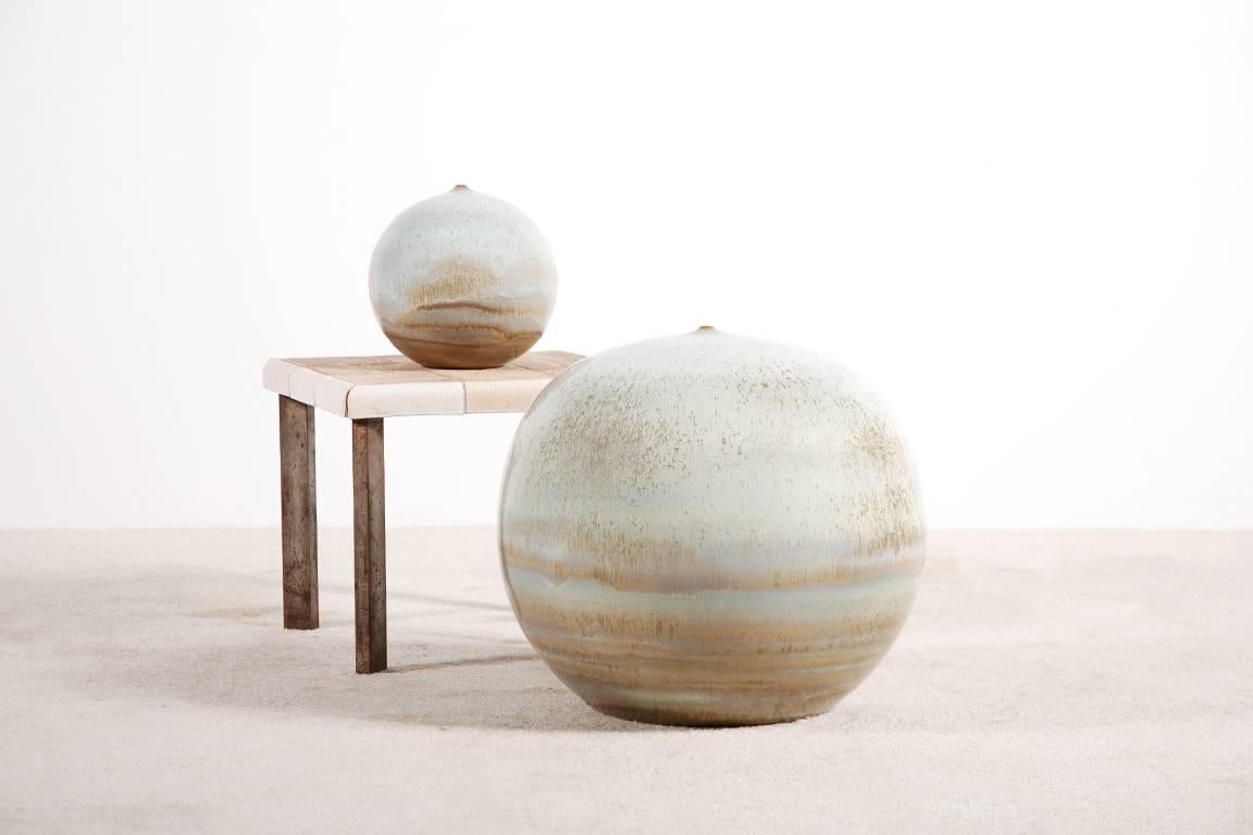 Set of two spherical sculptures by the Belgian ceramist Antonio Lampecco.

Round ceramic with crystallized enamel and a tiny aperture removing any function to the object.

A Humble Lampecco Quote:
My pots with tiny orifice have to be